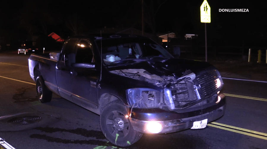 A pickup truck is left at the scene after the driver fatally struck a pedestrian in Quartz Hill on Dec. 12, 2018. (Credit: Luis Meza)