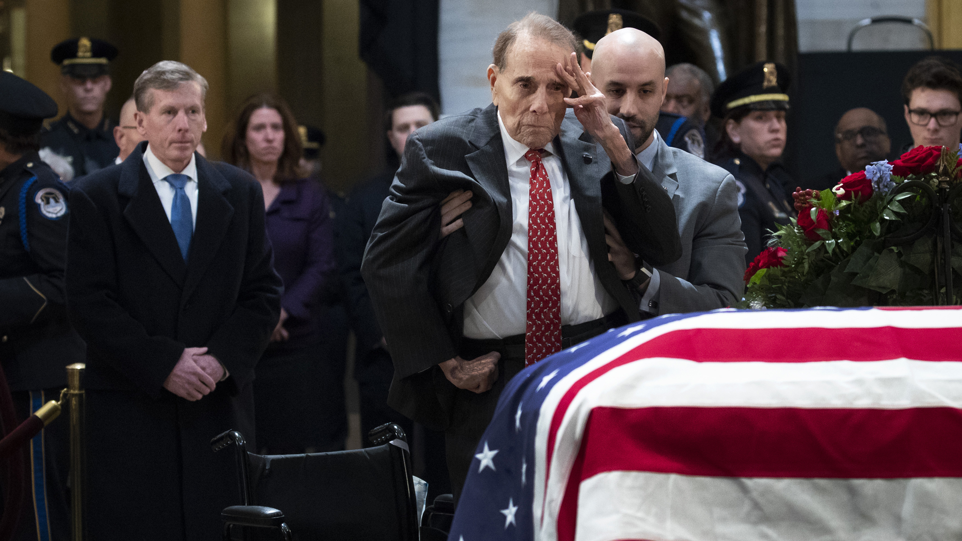 Former Senator Bob Dole salutes before the flag-draped casket of George H. W. Bush at the Capitol rotunda December 4, 2018. (Credit: ALEX EDELMAN/AFP/Getty Images)