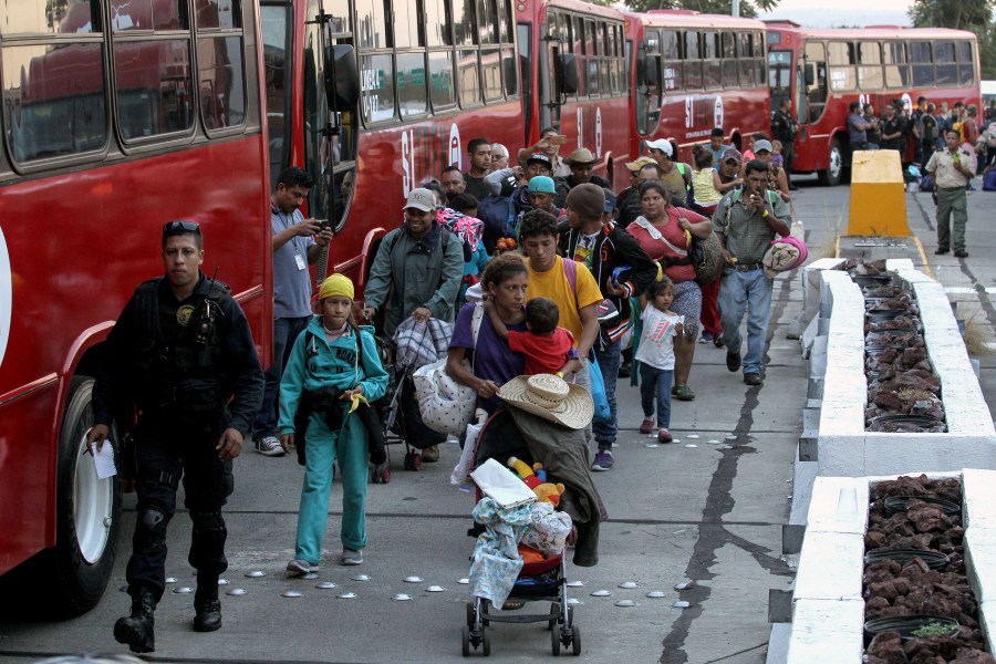 Central American migrants -mostly Hondurans- moving in a caravan towards the United States, board buses to head to a shelter in the outskirts of Zapotlanejo, Jalisco state, Mexico, on Nov. 11, 2018. (Credit: Ulises Ruiz/AFP/Getty Images)