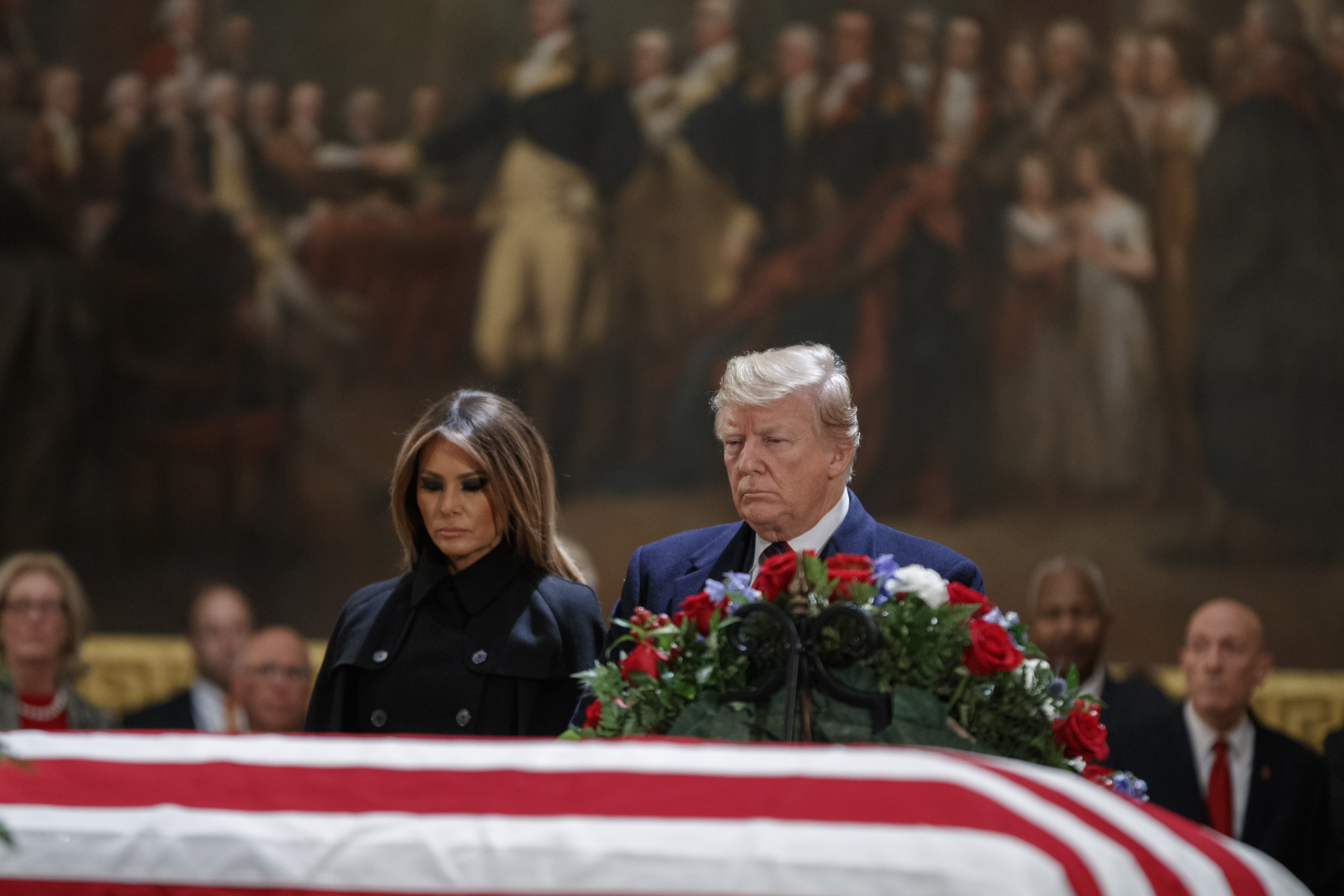 Donald Trump and first lady Melania Trump pay their respects to former President George H.W. Bush as he lies in state in the U.S. Capitol Rotunda on Dec. 3, 2018. (Credit: Shawn Thew-Pool/Getty Images)