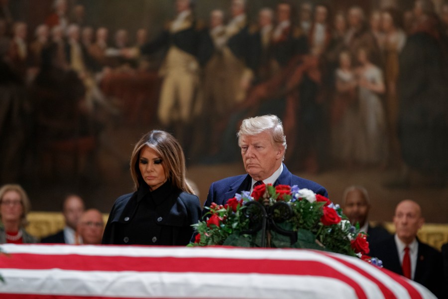 Donald Trump and first lady Melania Trump pay their respects to former President George H.W. Bush as he lies in state in the U.S. Capitol Rotunda on Dec. 3, 2018. (Credit: Shawn Thew-Pool/Getty Images)