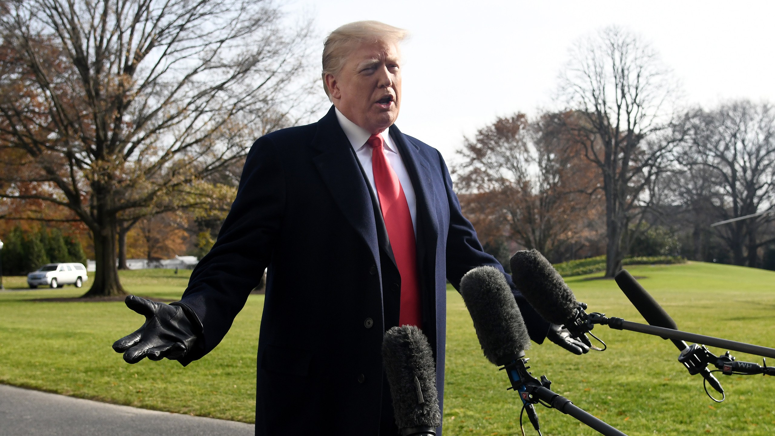 Donald Trump answers questions from the press while departing the White House on Dec. 8, 2018. (Credit: Olivier Douliery-Pool/Getty Images)