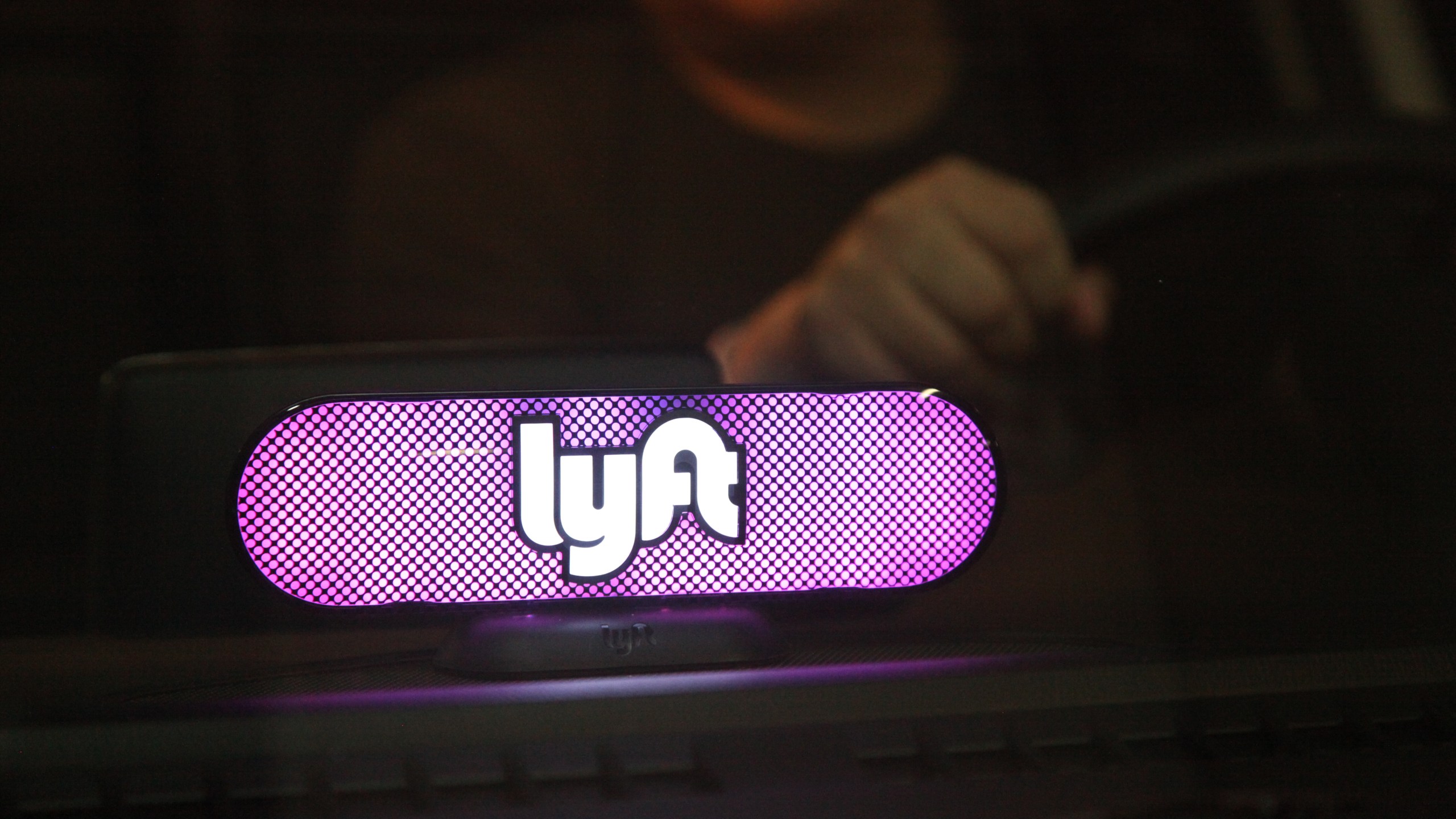 A Lyft logo glows on a driver's dashboard in San Francisco on Jan. 31, 2017. (Credit: Kelly Sullivan / Getty Images)