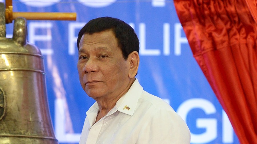 Philippine President Rodrigo Duterte rings one of the three Balangiga church bells during a ceremony in Balangiga in Eastern Samar province on Dec. 15, 2018. (Credit: TED ALJIBE/AFP/Getty Images)