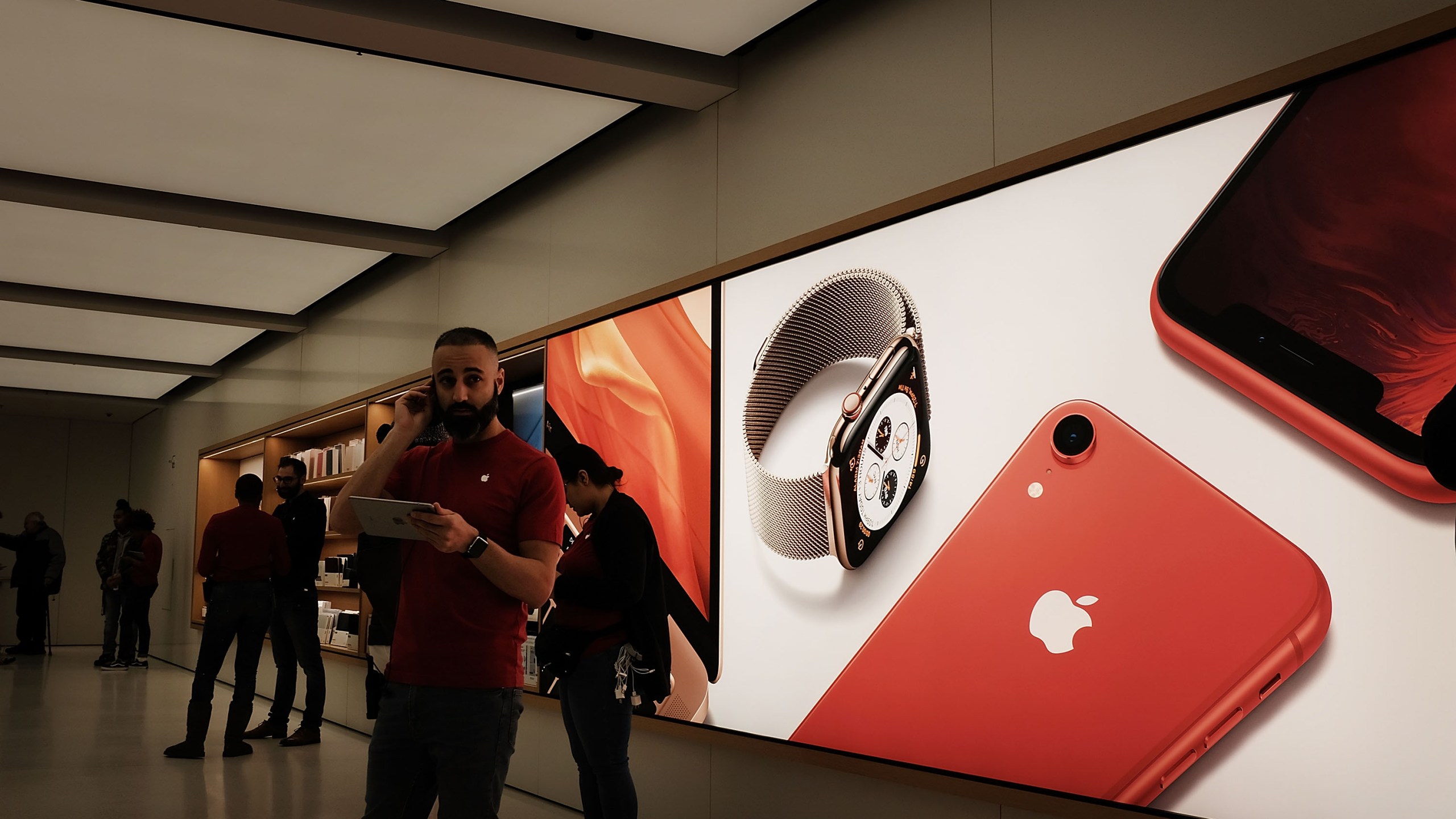 People stand in an Apple store in lower Manhattan on Nov. 20, 2018 in New York City. (Credit: Spencer Platt/Getty Images)