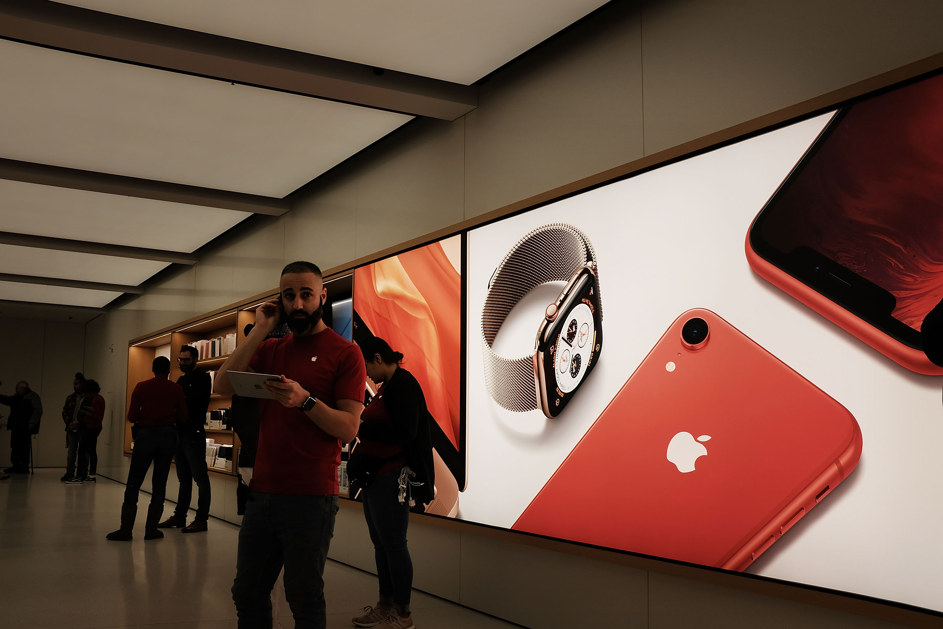 People stand in an Apple store in lower Manhattan on Nov. 20, 2018 in New York City. (Credit: Spencer Platt/Getty Images)