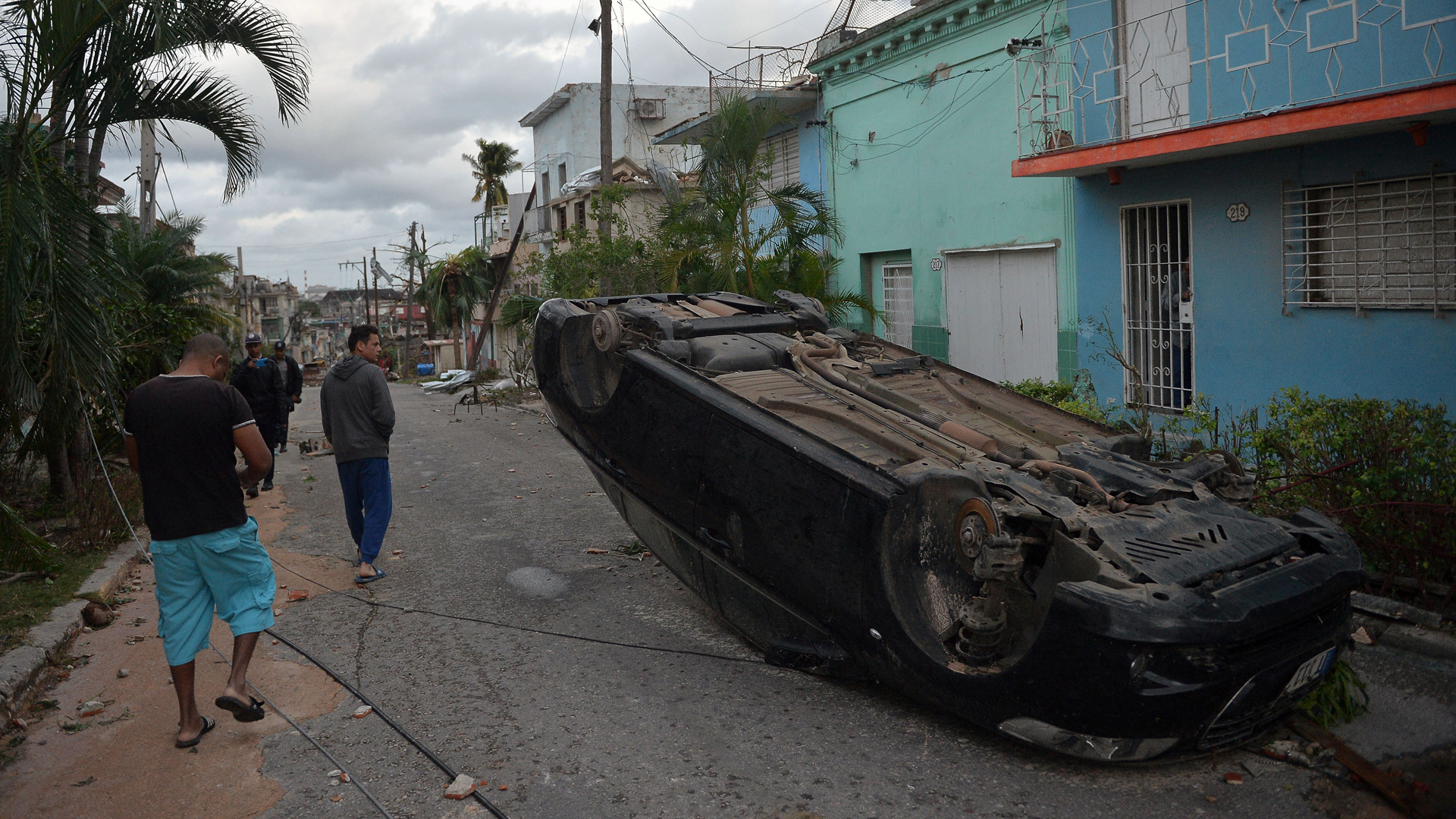 A car lies upside-down amid the street after the passage of a tornado in Havana, Cuba, on January 28, 2019. (Credit: YAMIL LAGE/AFP/Getty Images)