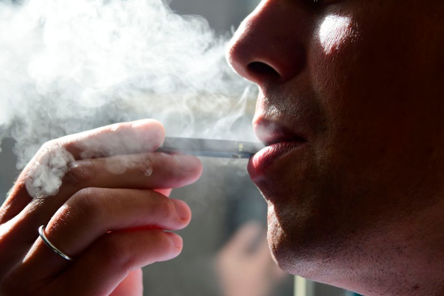 An image shows a man exhaling smoke from an e-cigarette in Washington, D.C. on Oct. 2, 2018.(Credit: Eva Hambach/AFP/Getty Images)