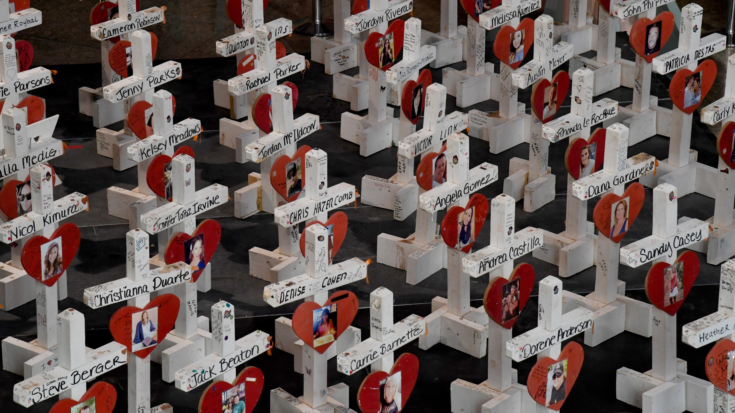 Some of the original 58 wooden crosses that were set up as part of a memorial at the Welcome to Fabulous Las Vegas sign after last year's massacre are displayed at "The Las Vegas Portraits Project, 1 October Memorial Exhibit" at the Clark County Government Center in Las Vegas on Oct. 1, 2018. (Credit: Ethan Miller / Getty Images)