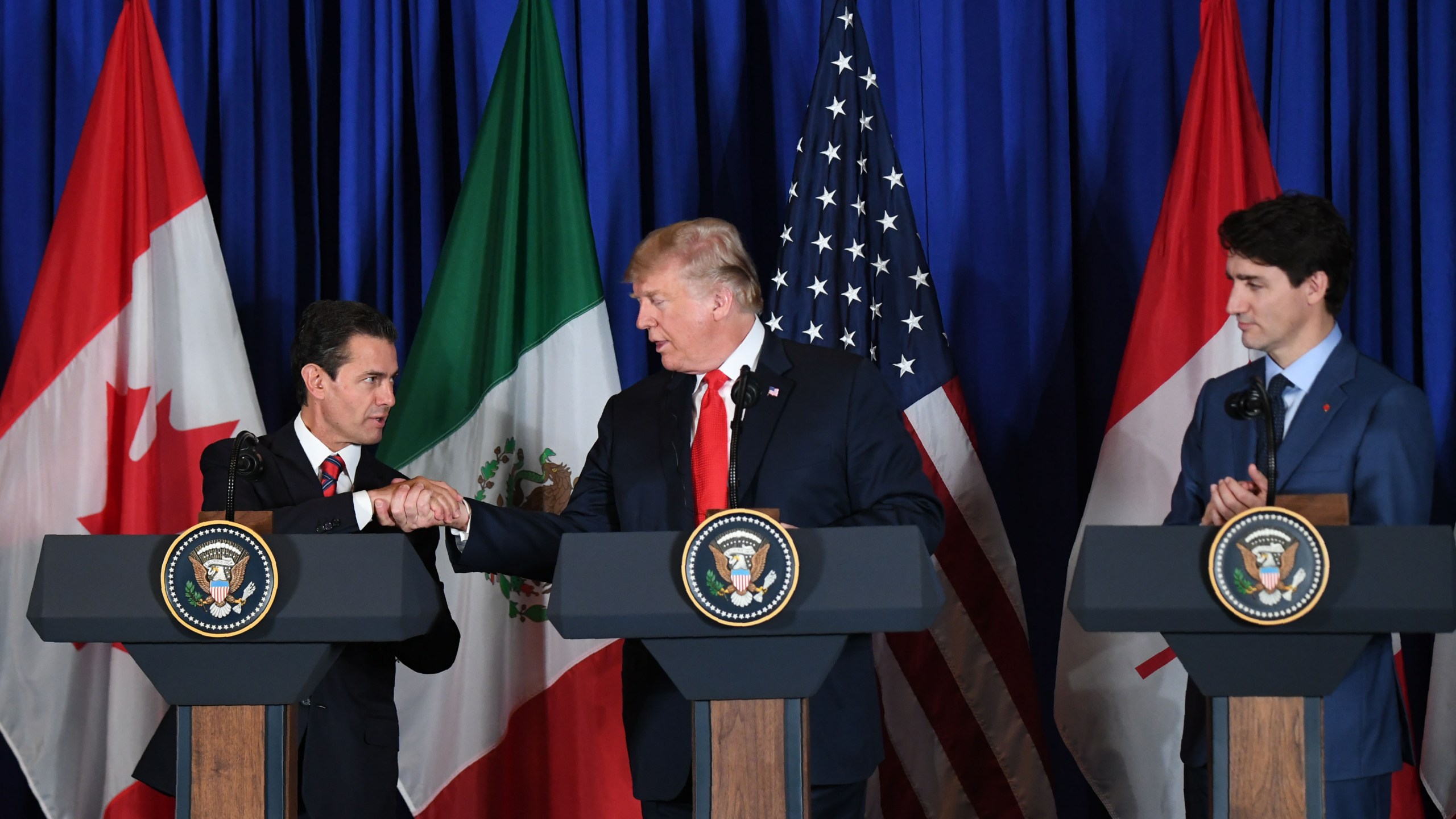 Mexican President Enrique Pena Nieto, U.S. President Donald Trump and Canadian Prime Minister Justin Trudeau deliver a statement on the signing of a new free trade agreement in Buenos Aires, on Nov. 30, 2018, on the sidelines of the G20 Leaders' Summit.(Credit: MARTIN BERNETTI/AFP/Getty Images)