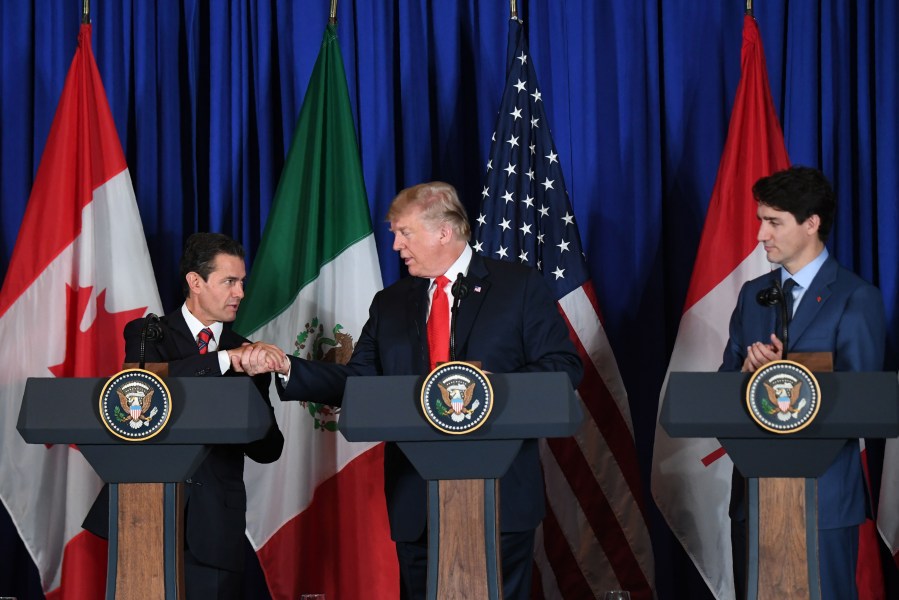 Mexican President Enrique Pena Nieto, U.S. President Donald Trump and Canadian Prime Minister Justin Trudeau deliver a statement on the signing of a new free trade agreement in Buenos Aires, on Nov. 30, 2018, on the sidelines of the G20 Leaders' Summit.(Credit: MARTIN BERNETTI/AFP/Getty Images)