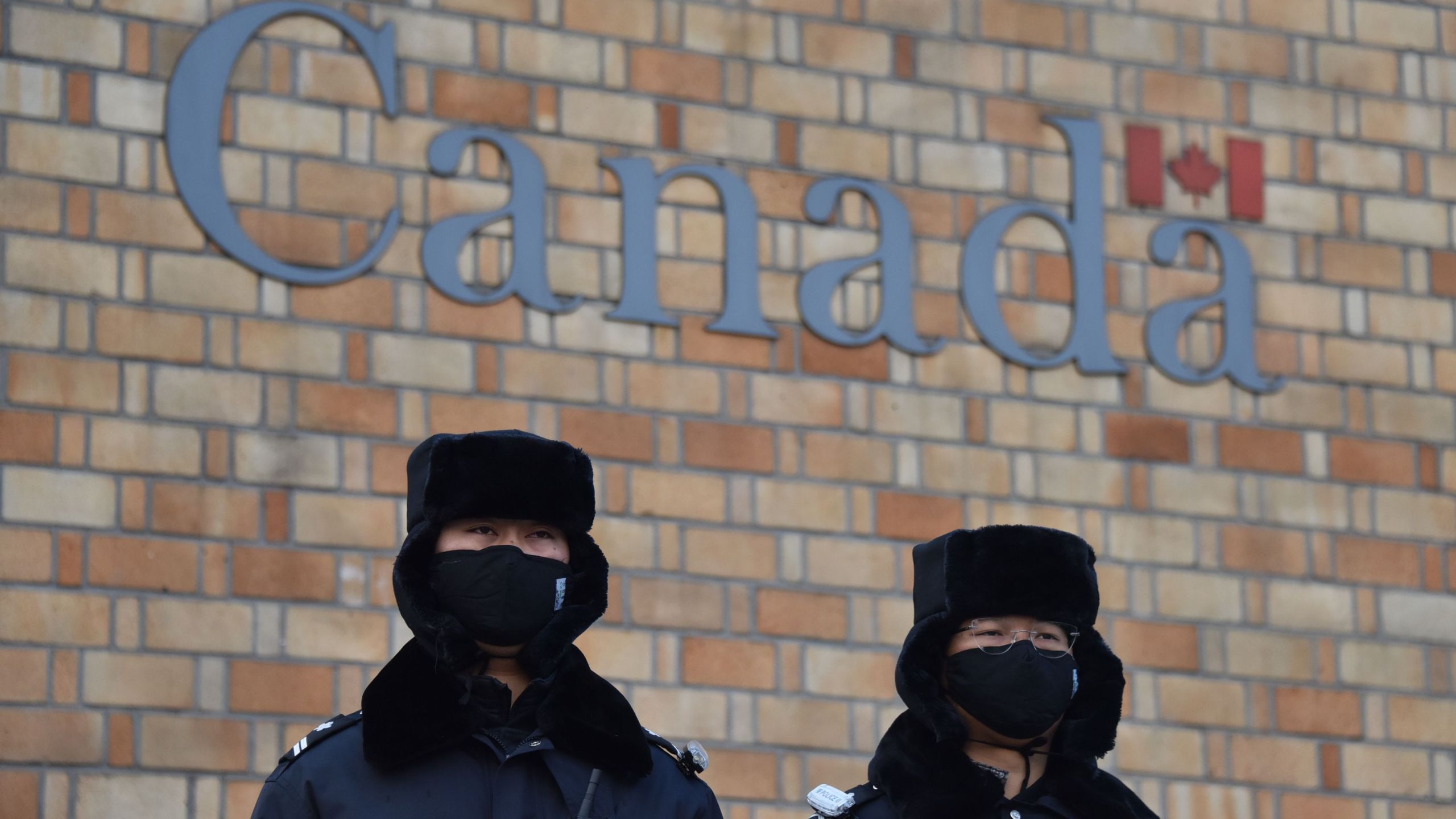 Chinese police officers stand guard outside the Canadian embassy in Beijing on December 10, 2018. (Credit: GREG BAKER/AFP/Getty Images)