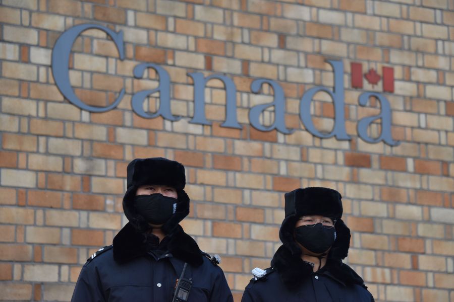 Chinese police officers stand guard outside the Canadian embassy in Beijing on December 10, 2018. (Credit: GREG BAKER/AFP/Getty Images)