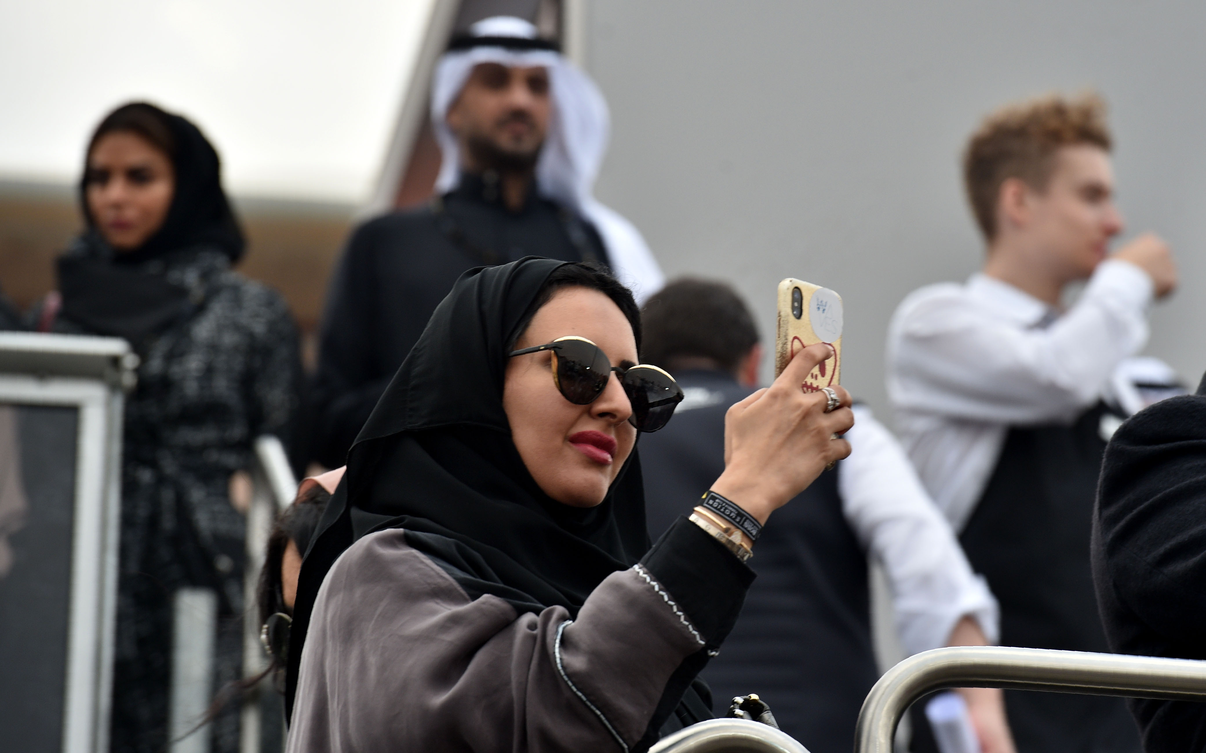 A Saudi woman takes photographs with her phone at the E-Prix Formula E Championship in Riyadh, on Dec. 15, 2018. (Credit: Fayez Nuerldine/AFP/Getty Images)