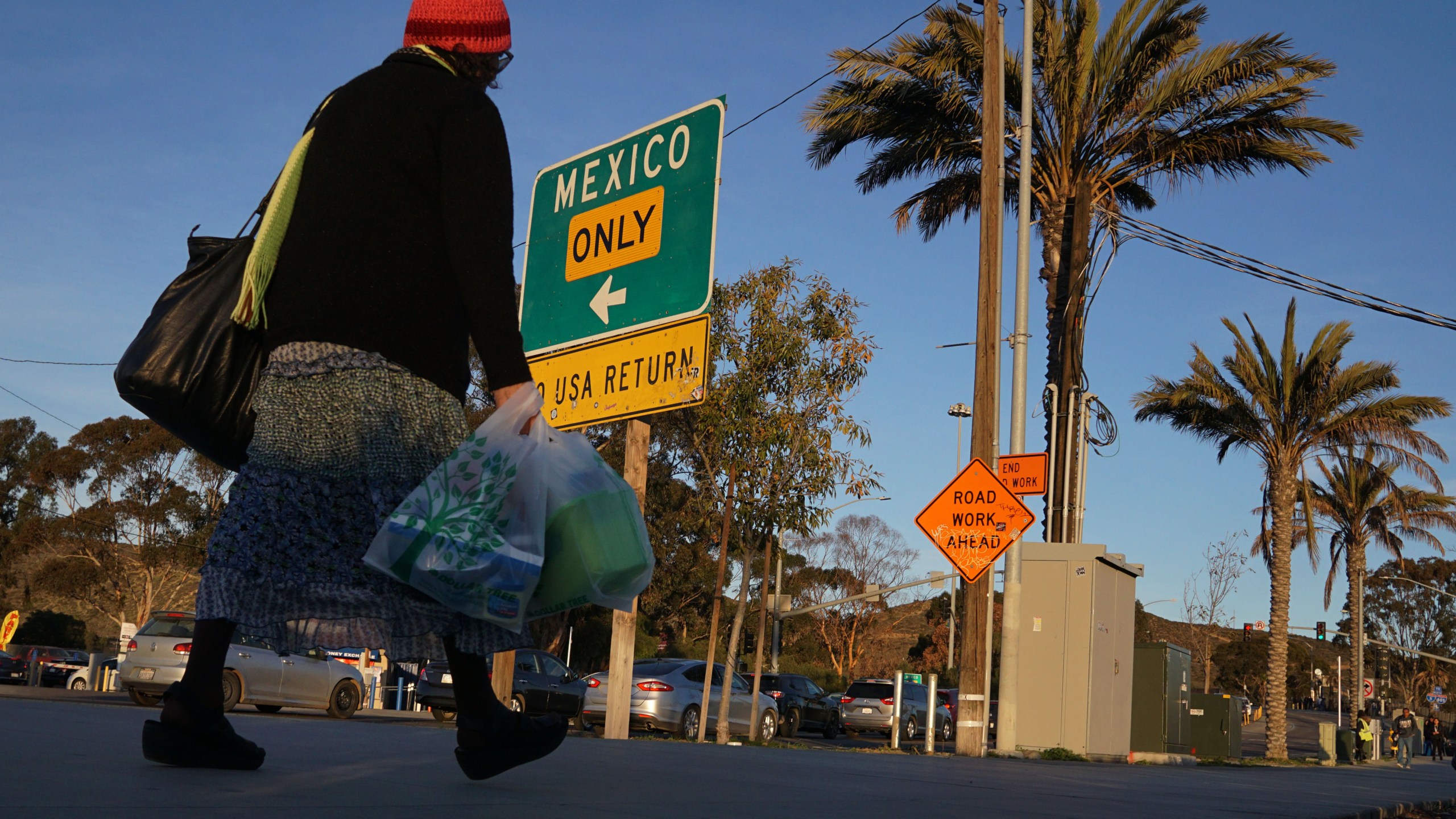 Shoppers walk towards the San Ysidro Port of Entry after making purchases at outlet malls along the U.S.-Mexico border on Dec. 29, 2018 in San Ysidro. (Credit: SANDY HUFFAKER/AFP/Getty Images)