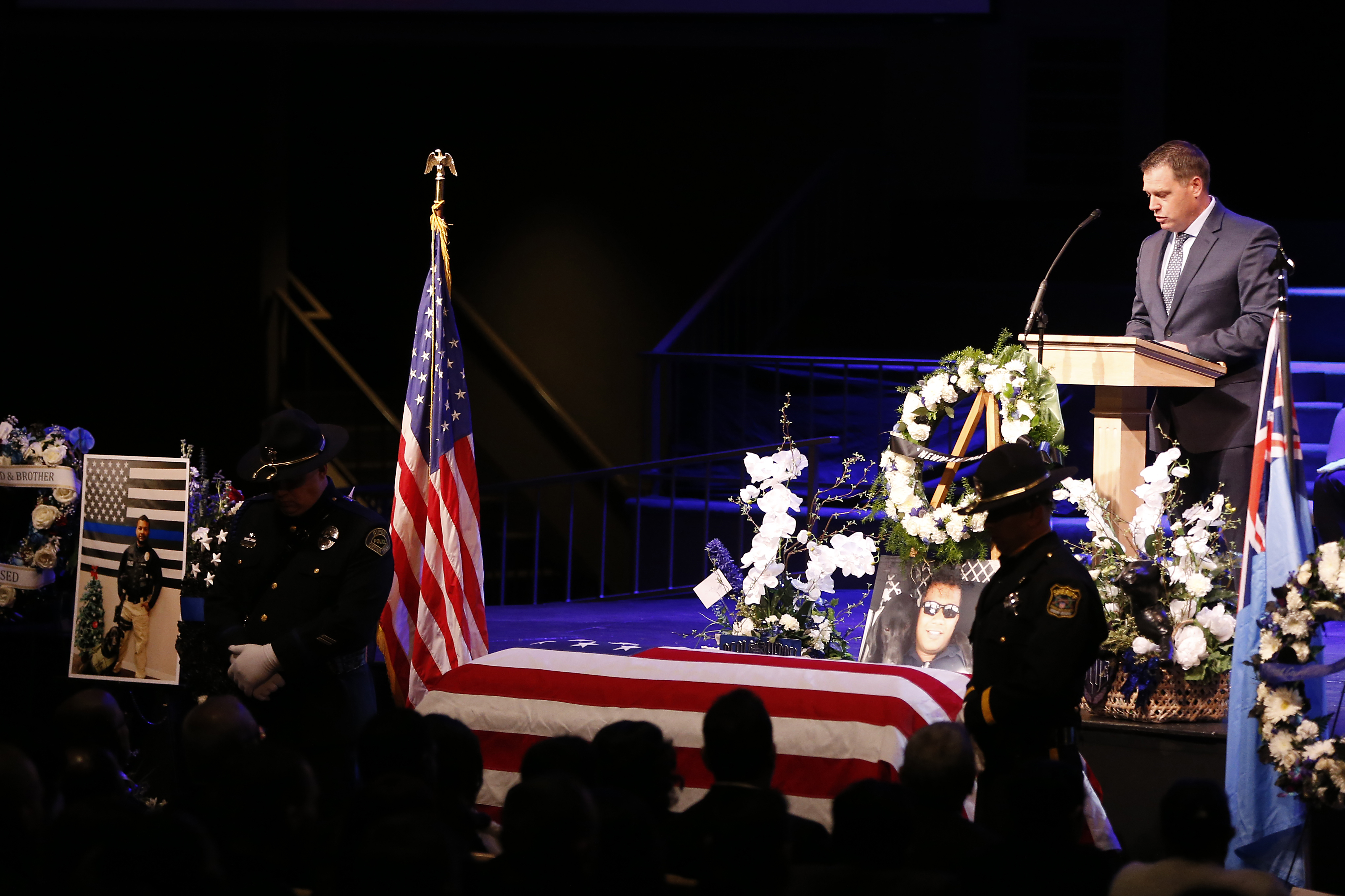 Officer Jeffrey Harmon of the Modesto Police Department speaks as the flag-draped casket of slain Newman police officer Ronil Singh is seen during a funeral service at CrossPoint Community Church on Jan. 5, 2019, in Modesto. (Credit: Stephen Lam/Getty Images)