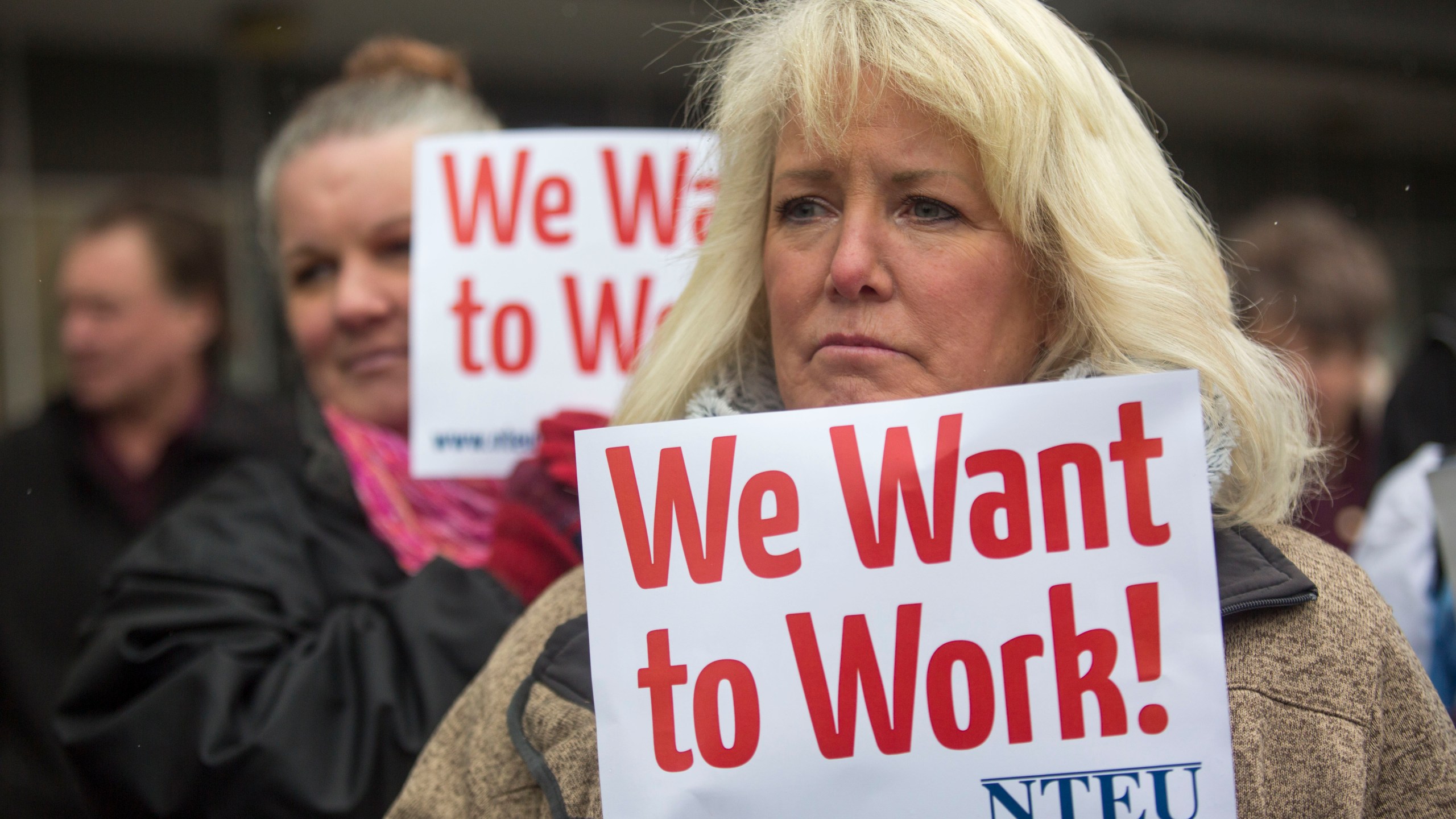 IRS employee Pam Crosbie and others hold signs protesting the government shutdown at the James V. Hansen Federal Building on Jan. 10, 2019, in Ogden, Utah. (credit: Natalie Behring/Getty Images)