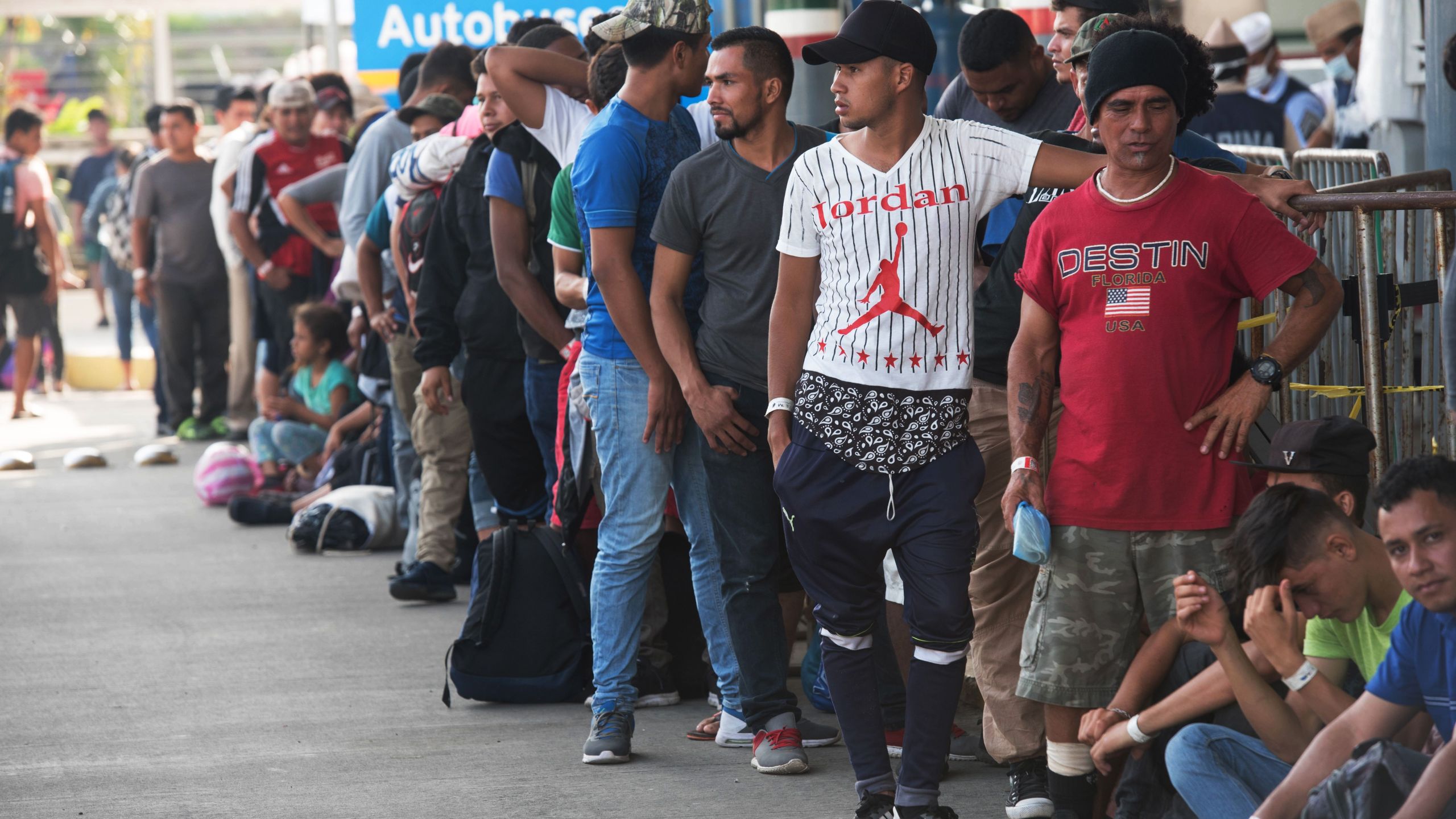 Central American migrants heading to the United States with a second caravan wait for immigration officials to give them their visitor card to continue on their journey, in Ciudad Hidalgo, Chiapas state, southern Mexico on Jan. 21, 2019. (Credit: Alejandro Melendez / AFP / Getty Images)