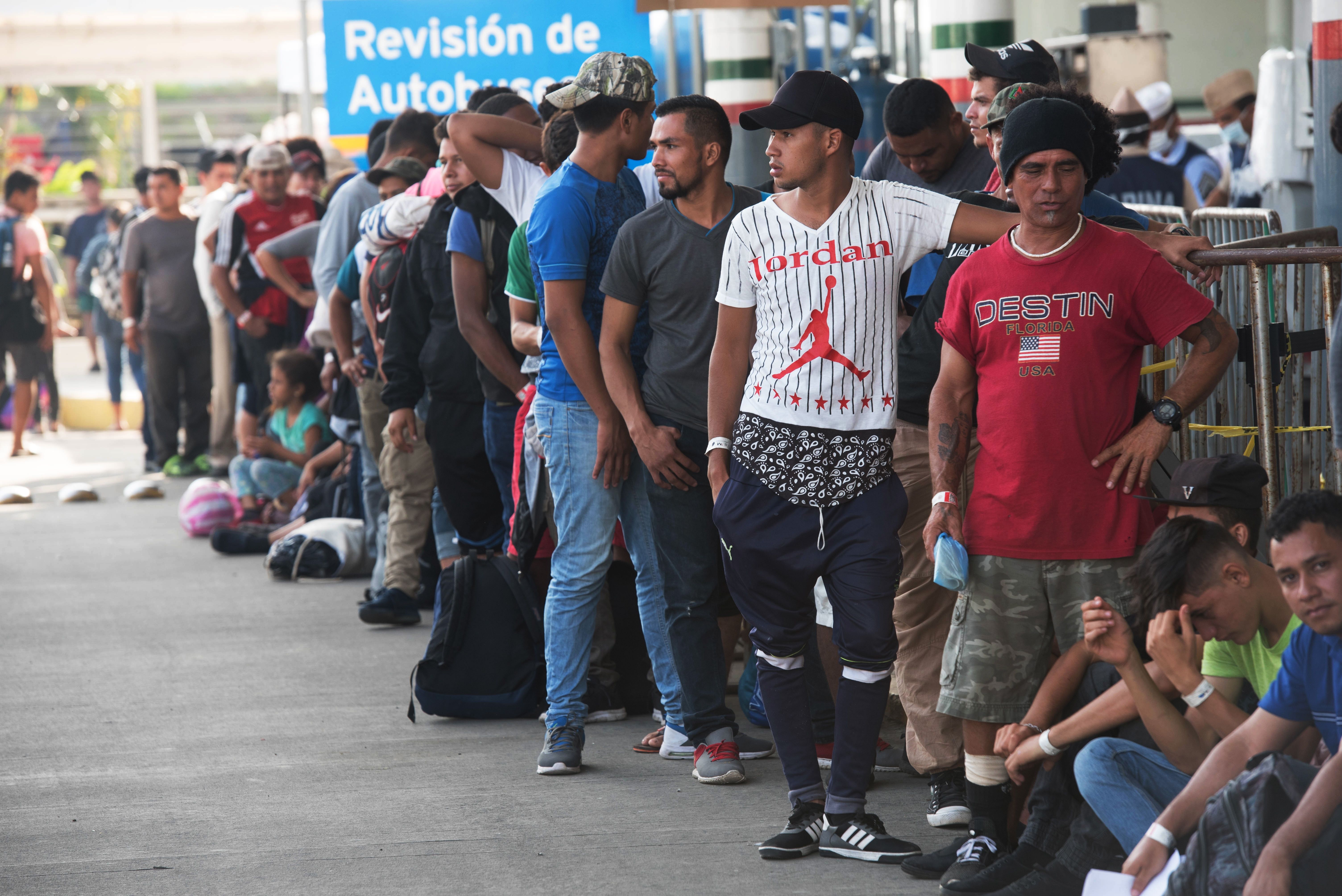 Central American migrants heading to the United States with a second caravan wait for immigration officials to give them their visitor card to continue on their journey, in Ciudad Hidalgo, Chiapas state, southern Mexico on Jan. 21, 2019. (Credit: Alejandro Melendez / AFP / Getty Images)