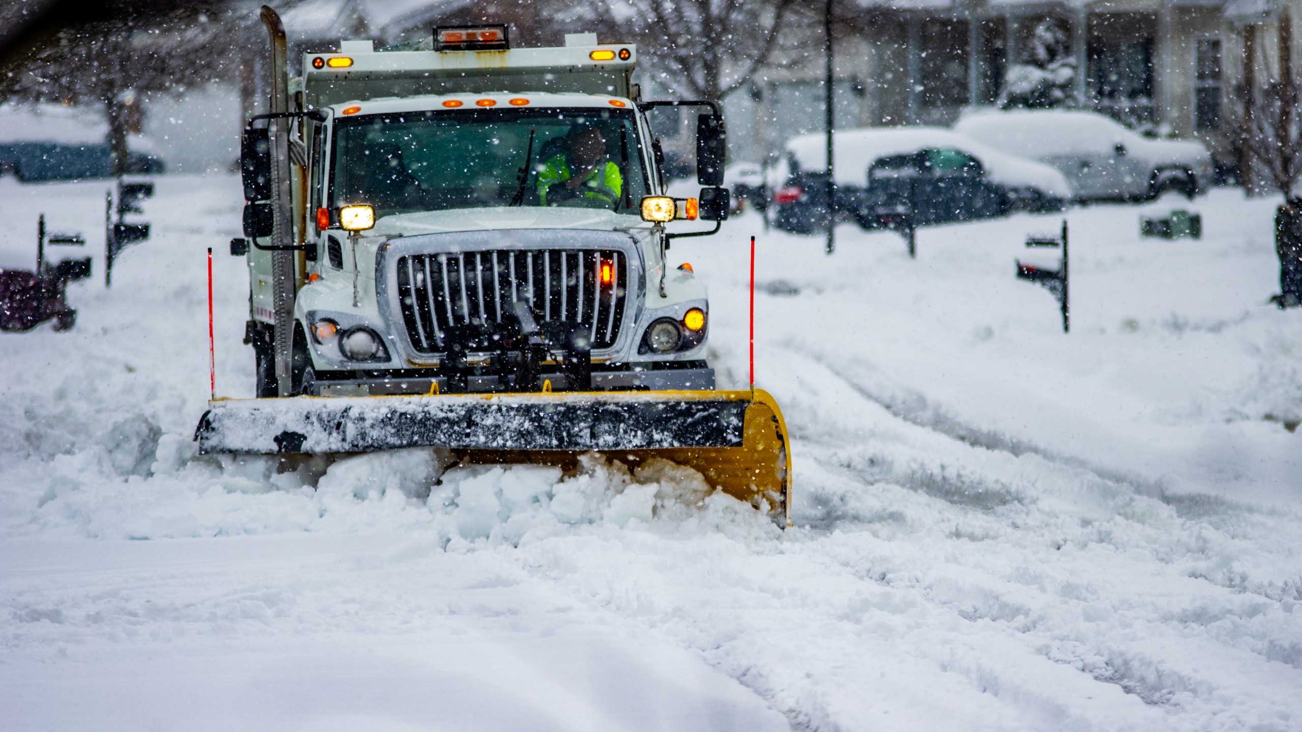 File photo of heavy equipment driver working to push snow to the side of the streets after a blizzard. (Credit: Getty Images)