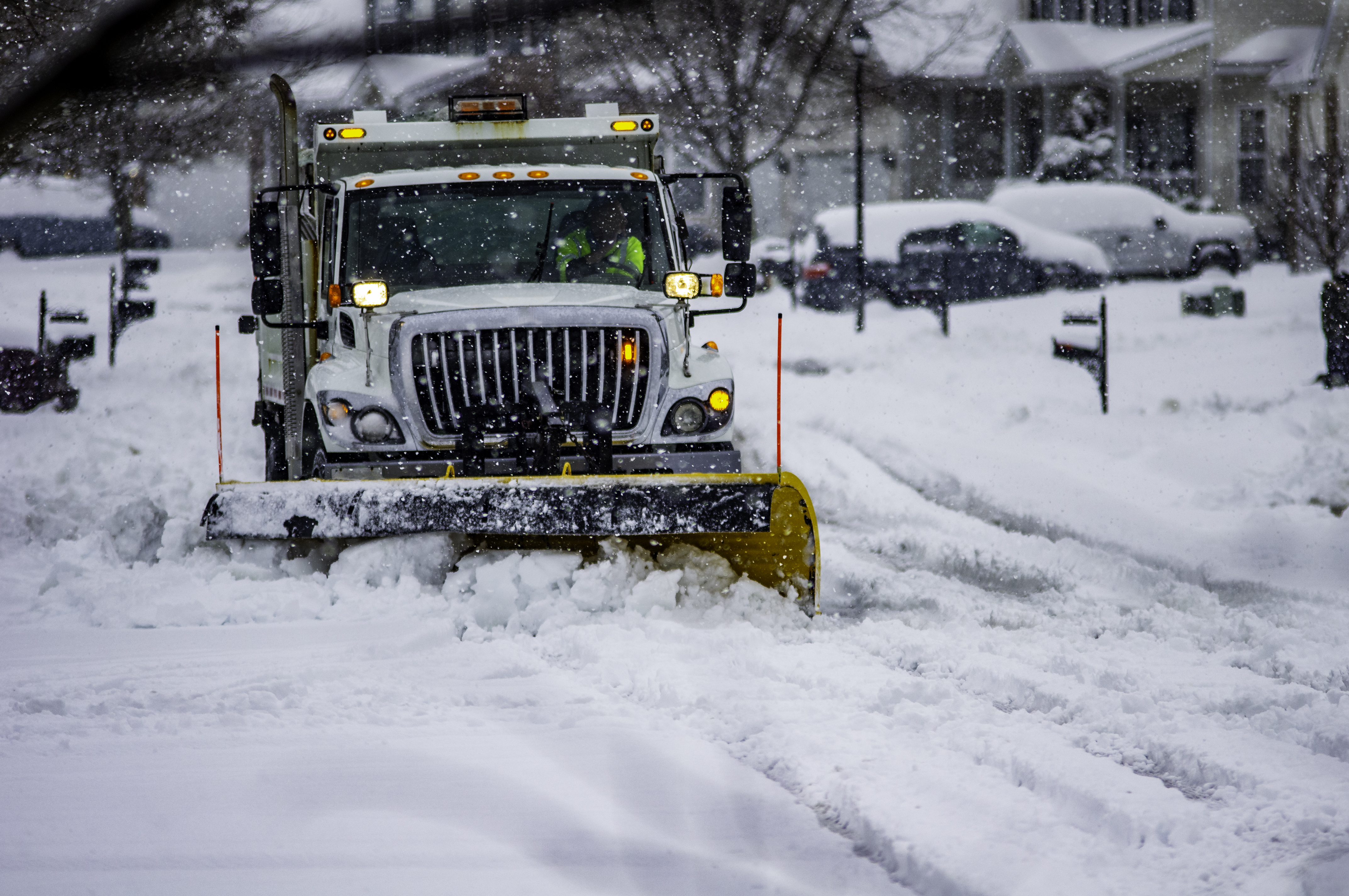 File photo of heavy equipment driver working to push snow to the side of the streets after a blizzard. (Credit: Getty Images)