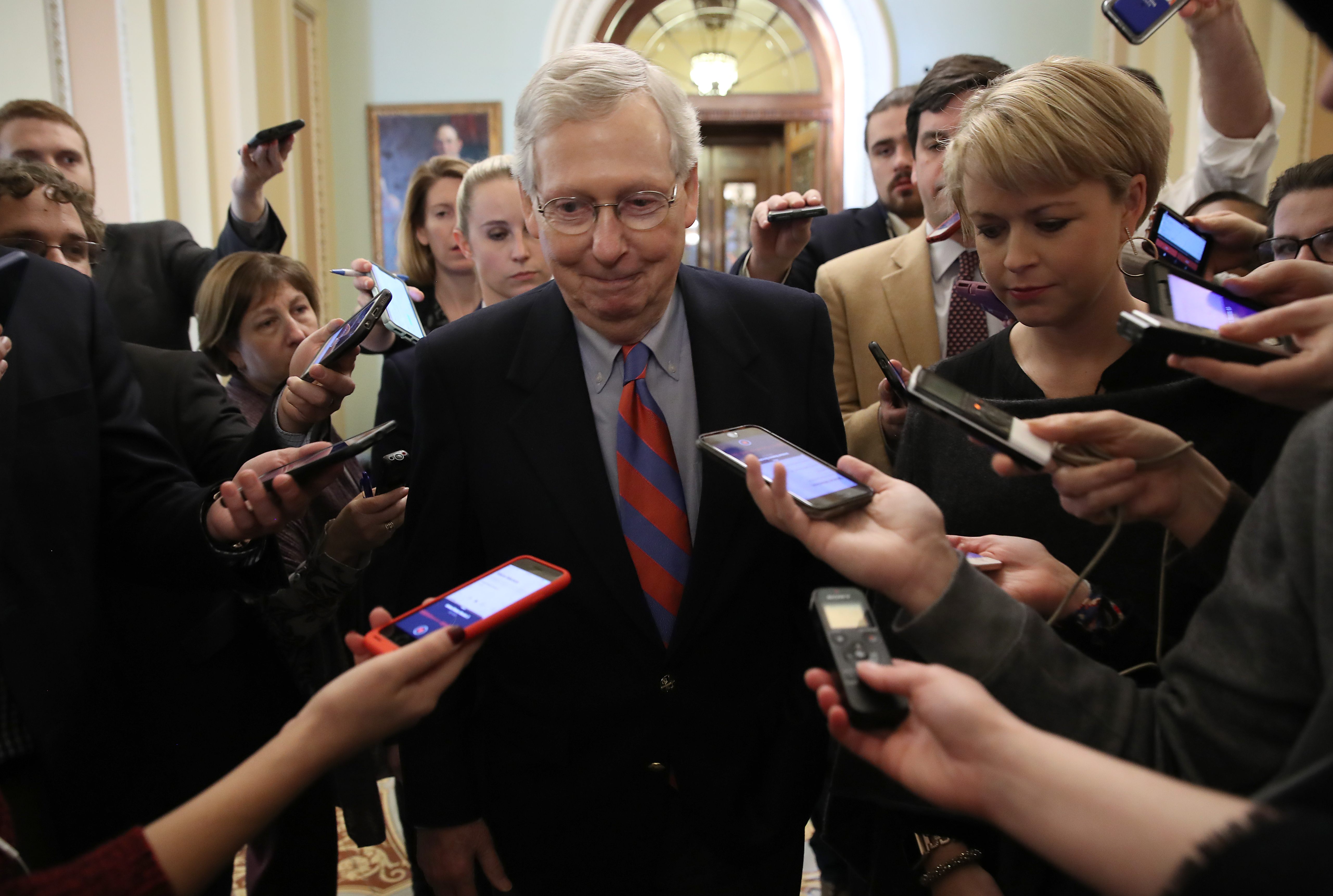 Senate Majority Leader Mitch McConnell (R-KY) smiles while talking with reporters following remarks on the Senate floor on Jan. 25, 2019. (Credit: Win McNamee/Getty Images)