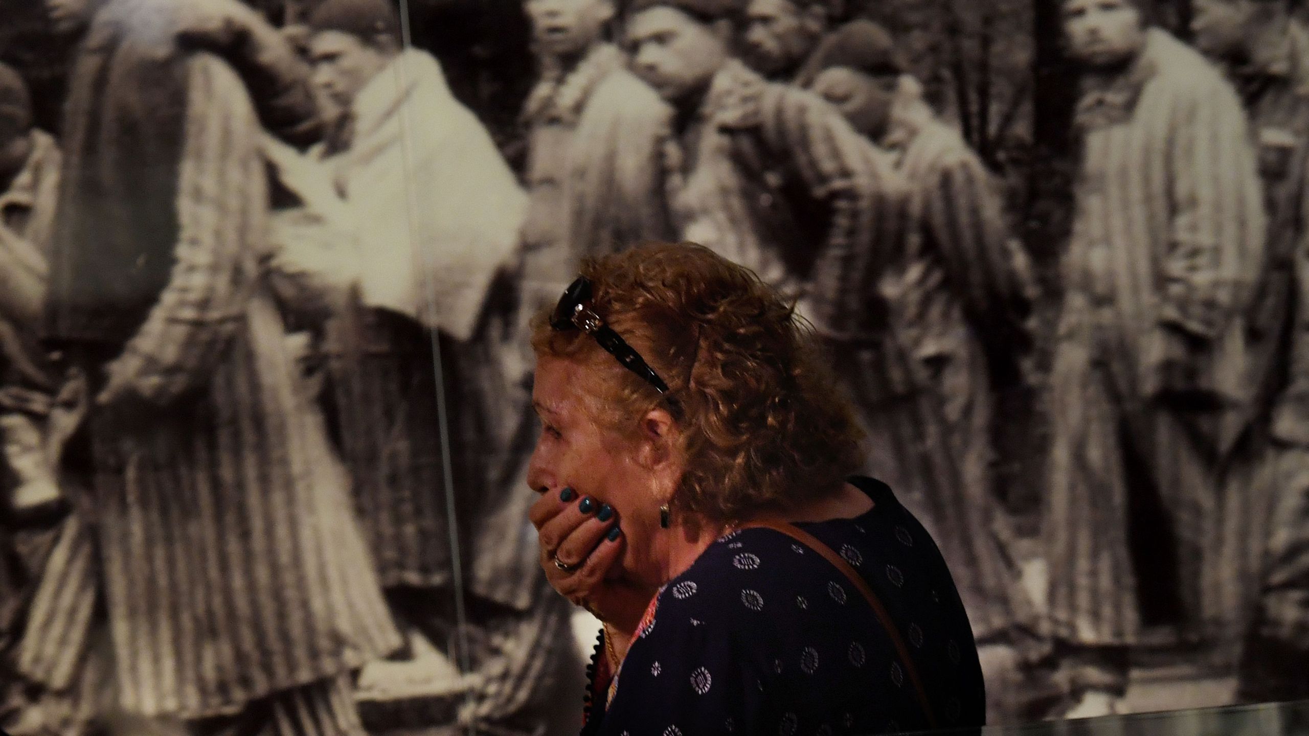 Rachel Sokolovski, the widow of a Holocaust survivor, reacts while viewing photographs at the Los Angeles Museum of the Holocaust in Los Angeles on April 23, 2017.(Credit: Mark Ralston/AFP/Getty Images)