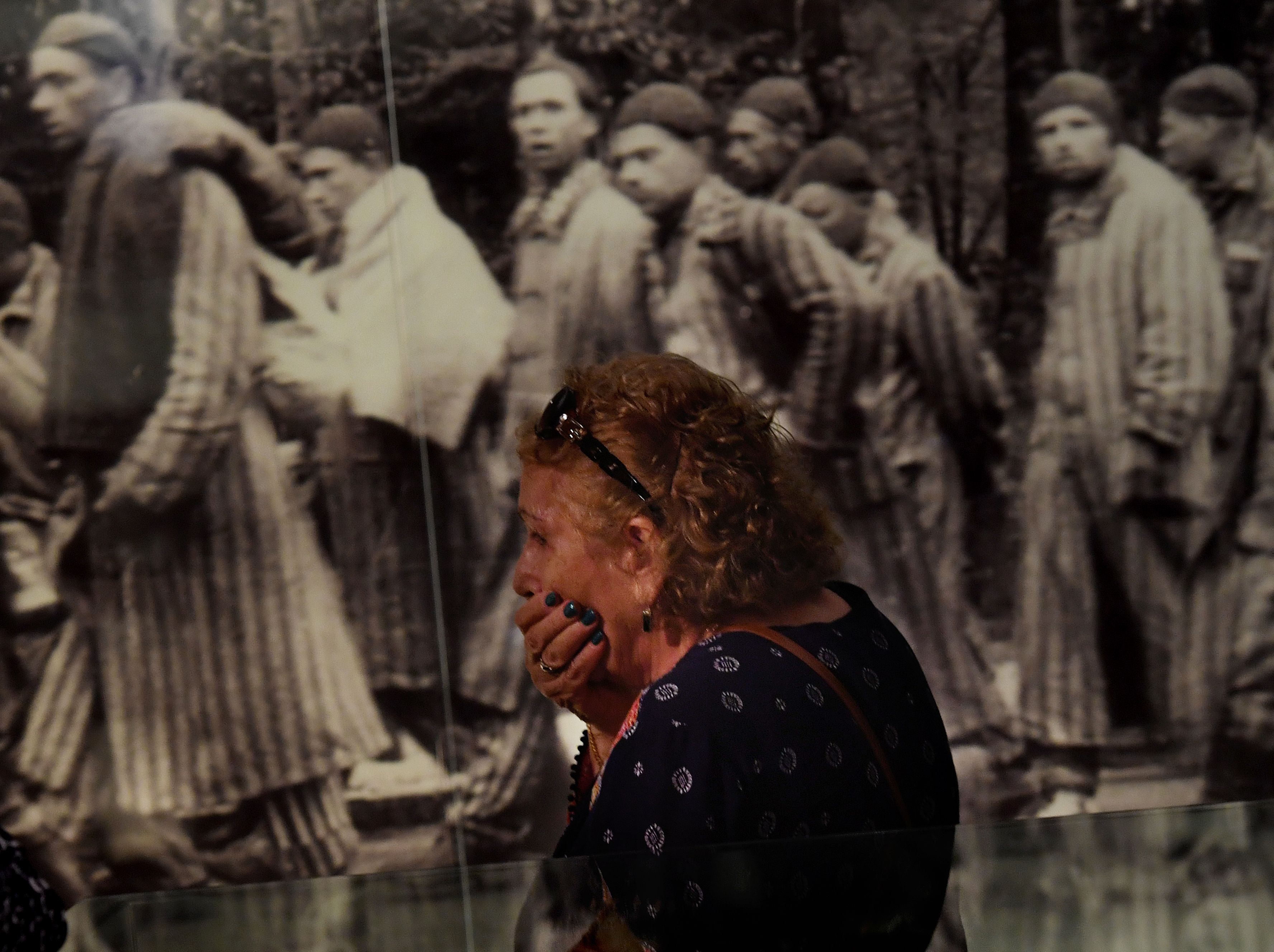 Rachel Sokolovski, the widow of a Holocaust survivor, reacts while viewing photographs at the Los Angeles Museum of the Holocaust in Los Angeles on April 23, 2017.(Credit: Mark Ralston/AFP/Getty Images)