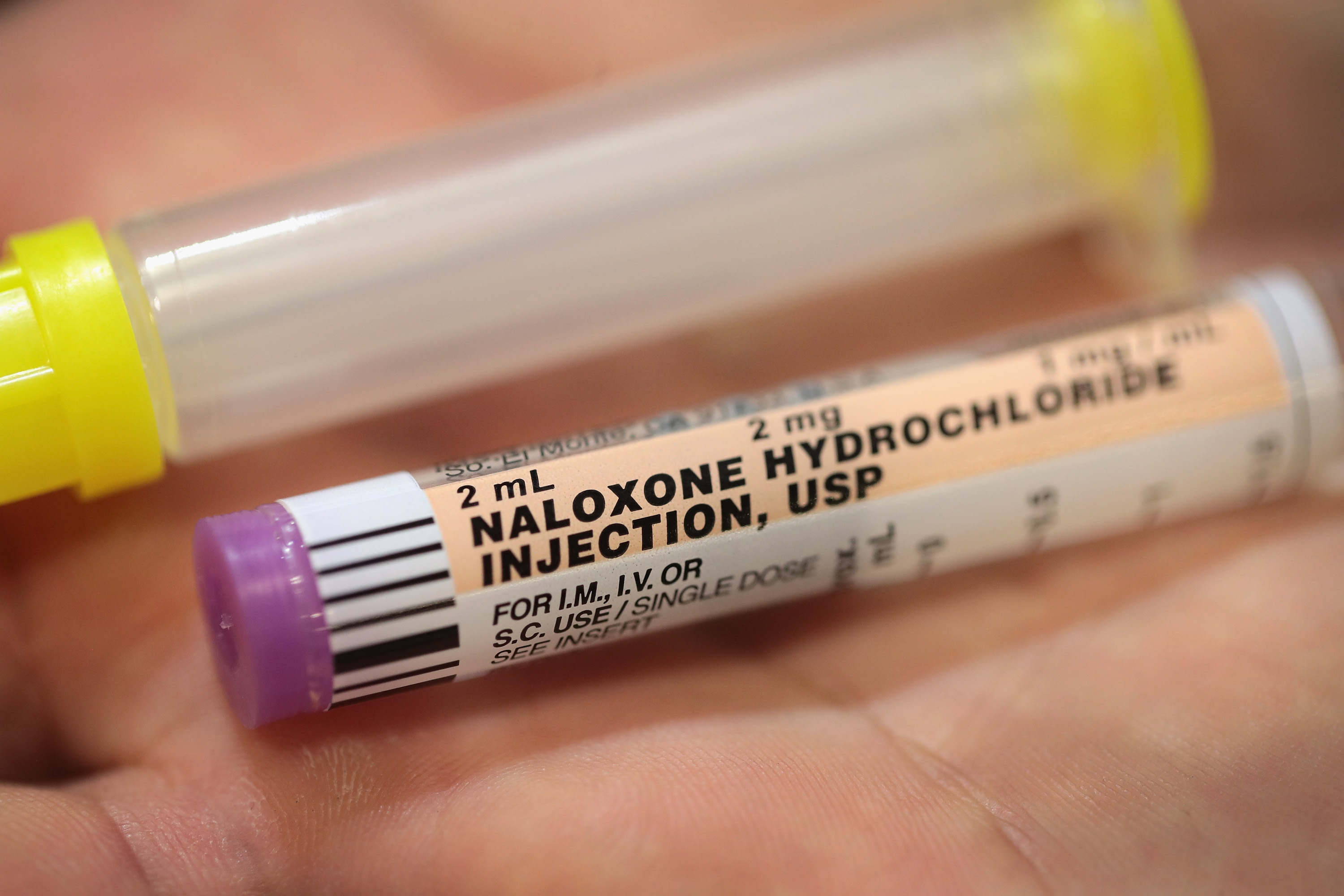 A firefighter displays a dose of Naloxone which emergency responders carry to treat opioid drug overdoses on July 14, 2017, in Rockford, Illinois.(Credit: Scott Olson/Getty Images)