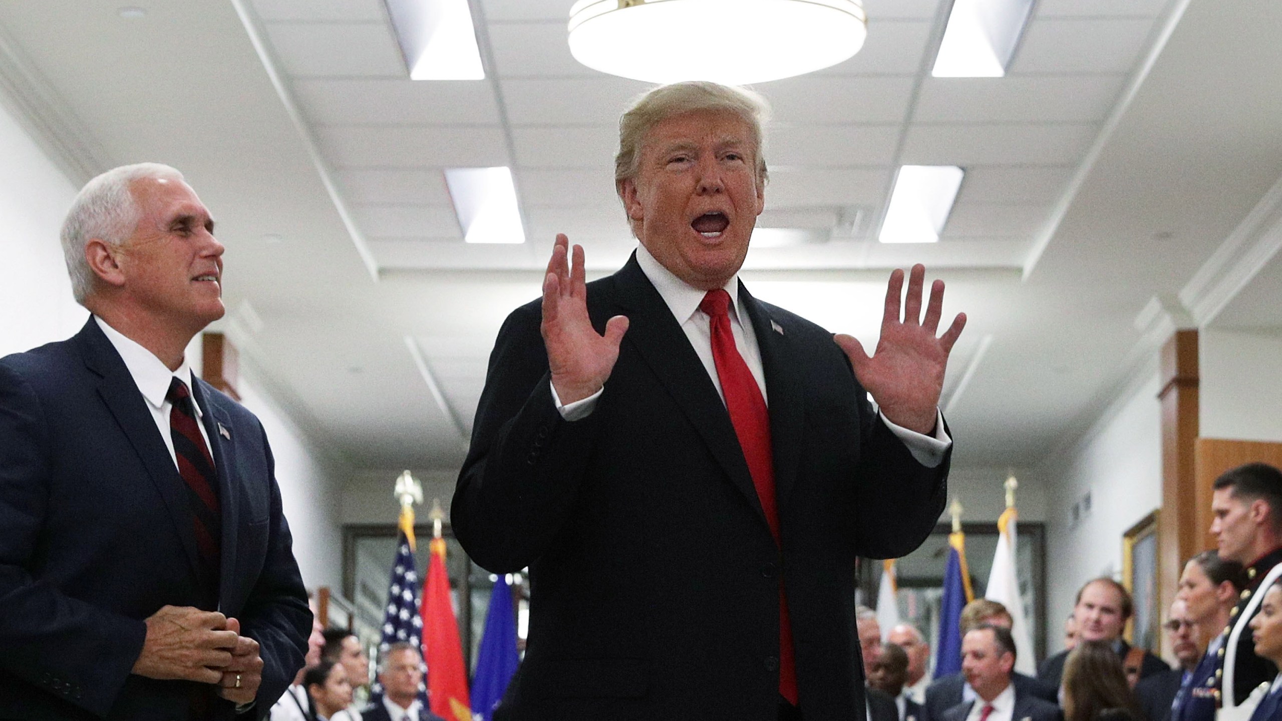 Donald Trump speaks to members of the media as Vice President Mike Pence looks on after a meeting at the Pentagon July 20, 2017 in Arlington, Virginia. (Credit: Alex Wong/Getty Images)