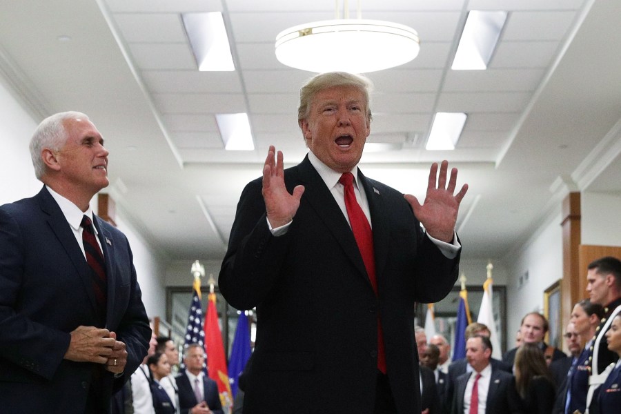 Donald Trump speaks to members of the media as Vice President Mike Pence looks on after a meeting at the Pentagon July 20, 2017 in Arlington, Virginia. (Credit: Alex Wong/Getty Images)