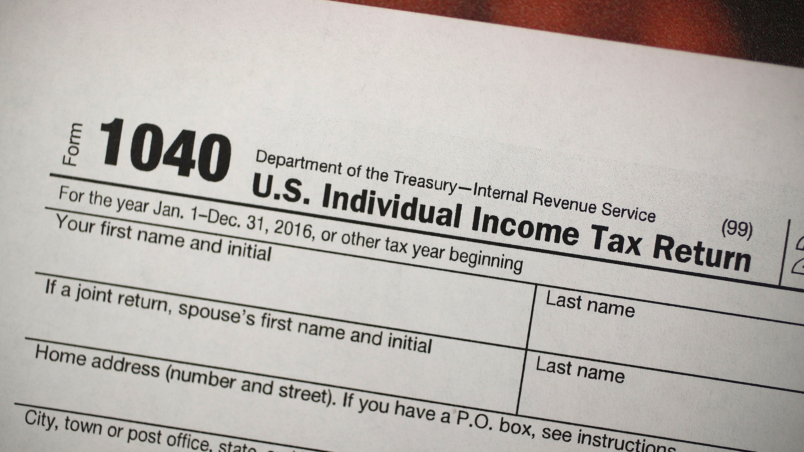 A copy of a IRS 1040 tax form is seen at an H&R Block office in this file photo.(Credit: Joe Raedle/Getty Images)