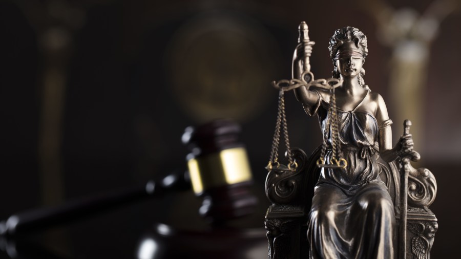 Lady Justice is shown blindfolded on a judge's desk in a file image. (Credit: iStock / Getty Images Plus)