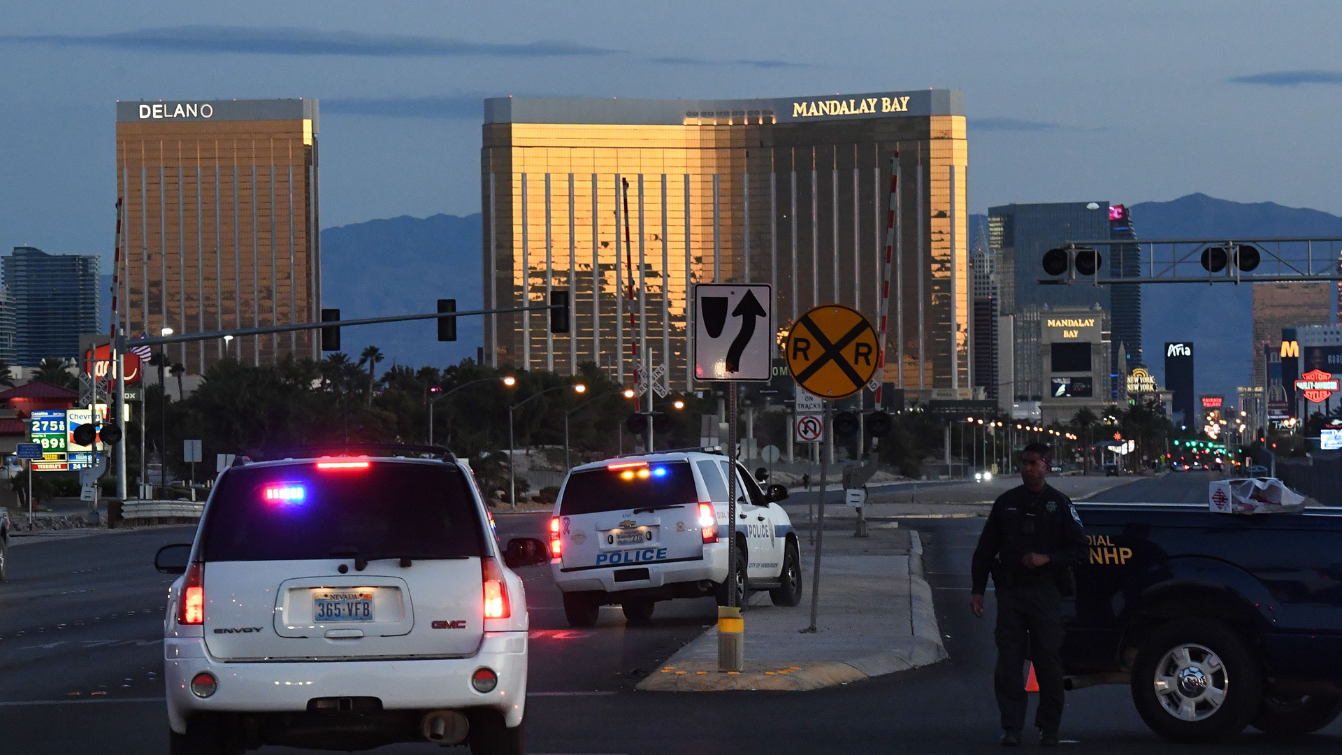 Police form a perimeter around the road leading to the Mandalay Hotel (background) after a gunman killed at least 50 people and wounded more than 400 others when he opened fire on a country music concert in Las Vegas, Nevada on October 2, 2017. (Credit: MARK RALSTON/AFP/Getty Images)