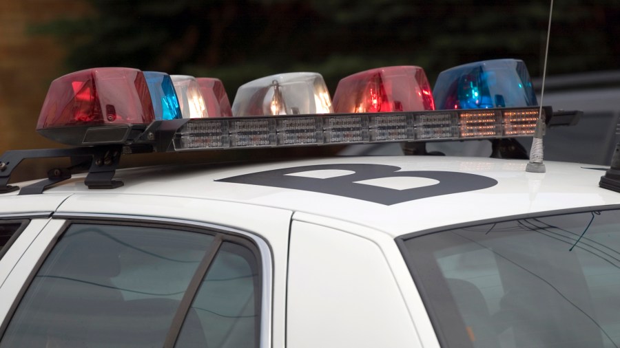 A police car with flashing lights on patrol. (Credit: iStock / Getty Images Plus)