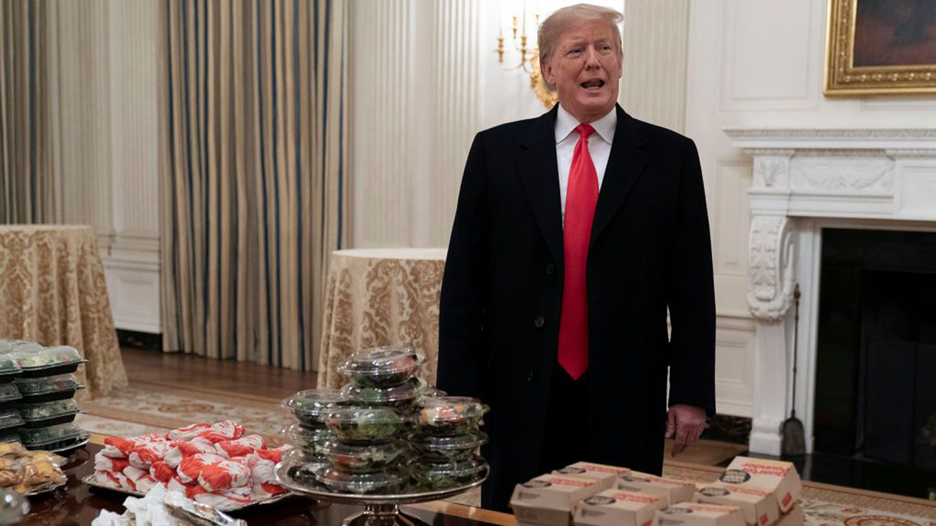 President Donald Trump presents fast food to be served to the Clemson Tigers in celebration of their national championship at the White House on January 14, 2019 in Washington, DC. Clemson won their second title in three years after beating Alabama 44-16 on January 7th. (Photo by Chris Kleponis - Pool/Getty Images)