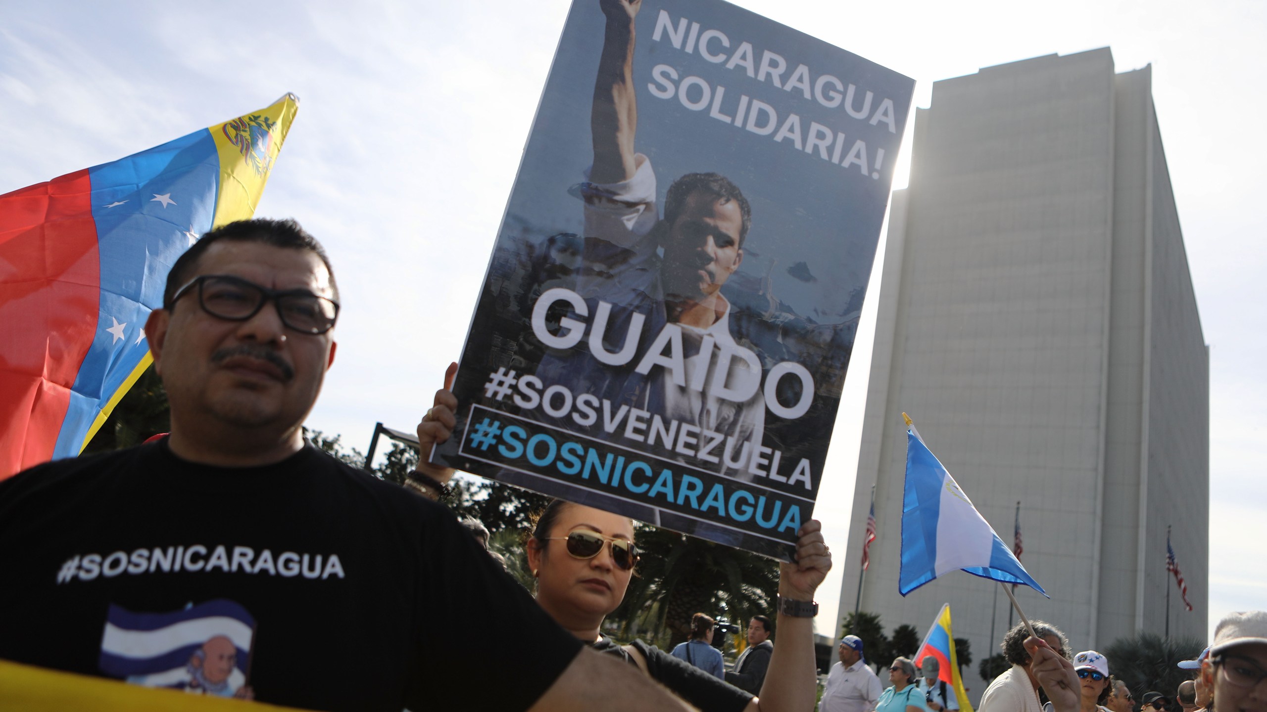 Anti-Maduro demonstrators gather as one holds a poster of Venezuelan opposition leader Juan Guaido, outside the Federal Building, on January 26, 2019 in Los Angeles, California. The protestors called for Guaido to be installed as the head of state of Venezuela. Some Nicaraguan protestors joined the demonstration in solidarity. (Credit: Mario Tama/Getty Images)