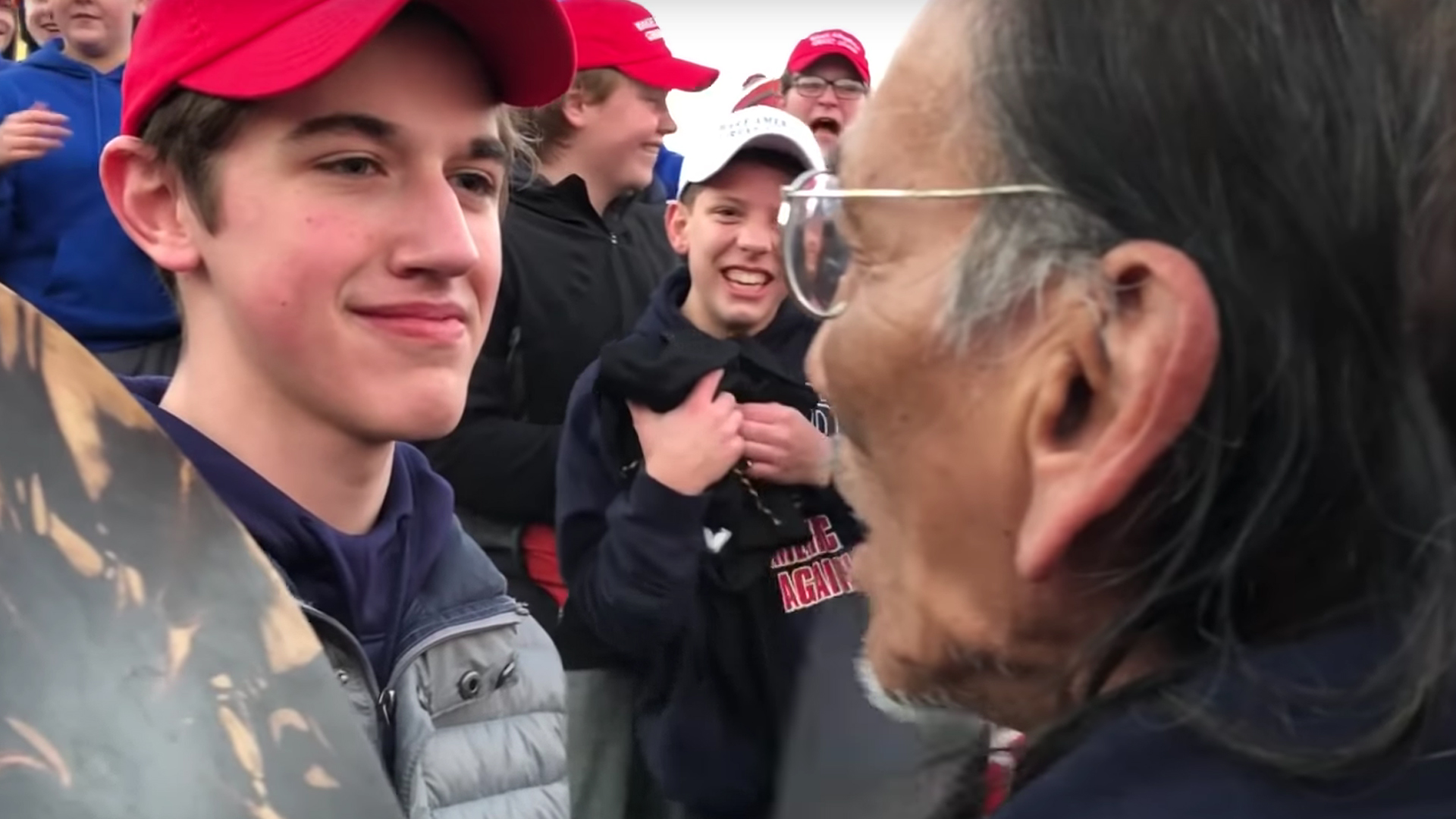 A screenshot from a video posted to YouTube on Jan. 18, 2019 by user KC NOLAND shows a boy wearing a MAGA hat in front of a Native American man.