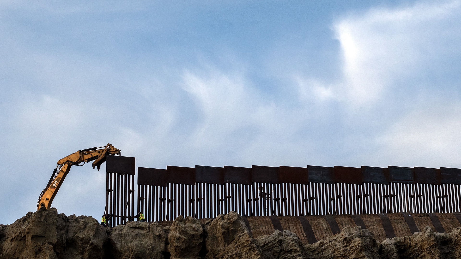 A crew works replacing the old border fence along a section of the U.S.-Mexico border, as seen from Tijuana, in Baja California state, Mexico, on Jan. 8, 2019. (Credit: GUILLERMO ARIAS/AFP/Getty Images)