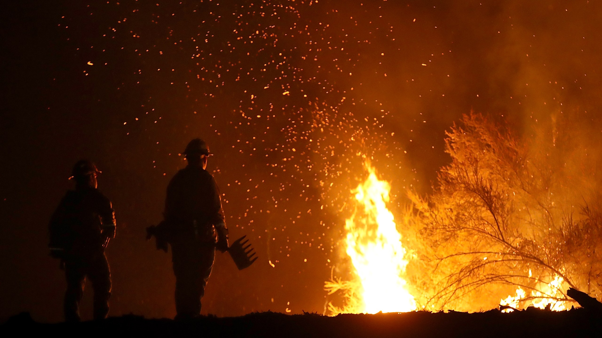 Cal Fire firefighters monitor a back fire as they battle the Medocino Complex Fire on Aug. 7, 2018, near Lodoga. (Credit: Justin Sullivan/Getty Images)