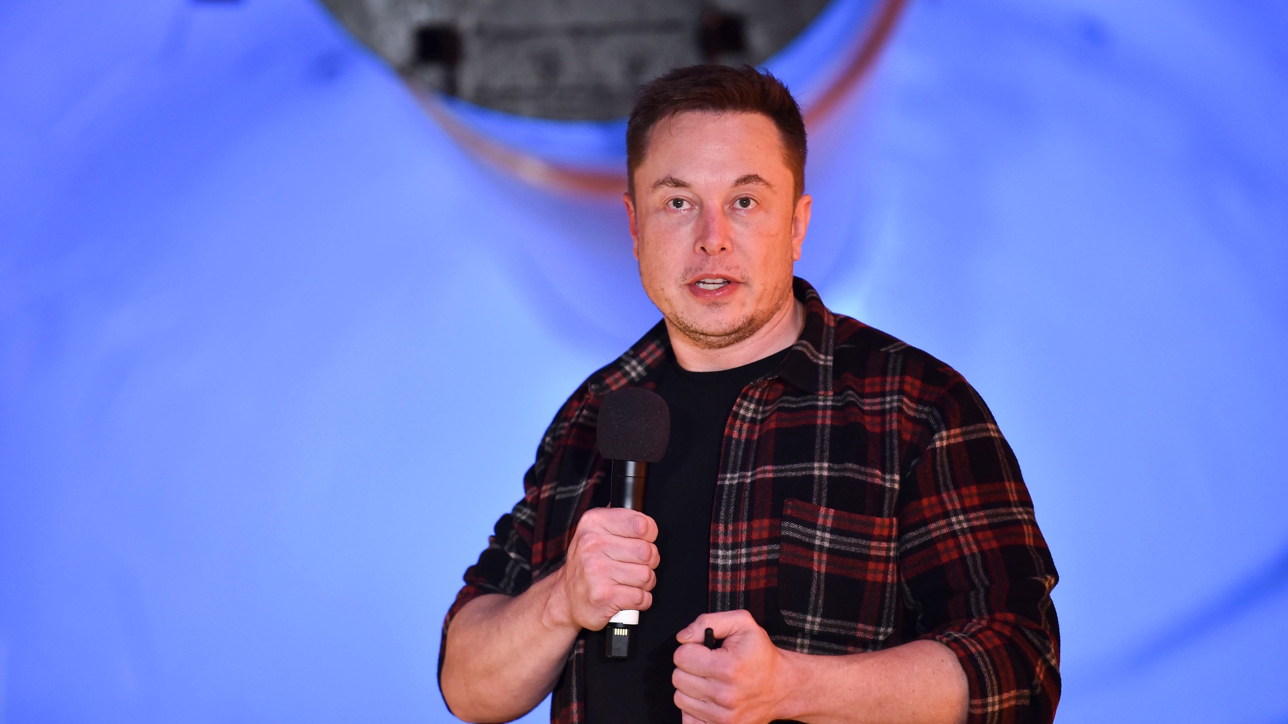 Elon Musk, co-founder and CEO of Tesla, speaks at an unveiling event for The Boring Co.'s test tunnel in Hawthorne on Dec. 18, 2018. (Credit: Robyn Beck / Getty Images)