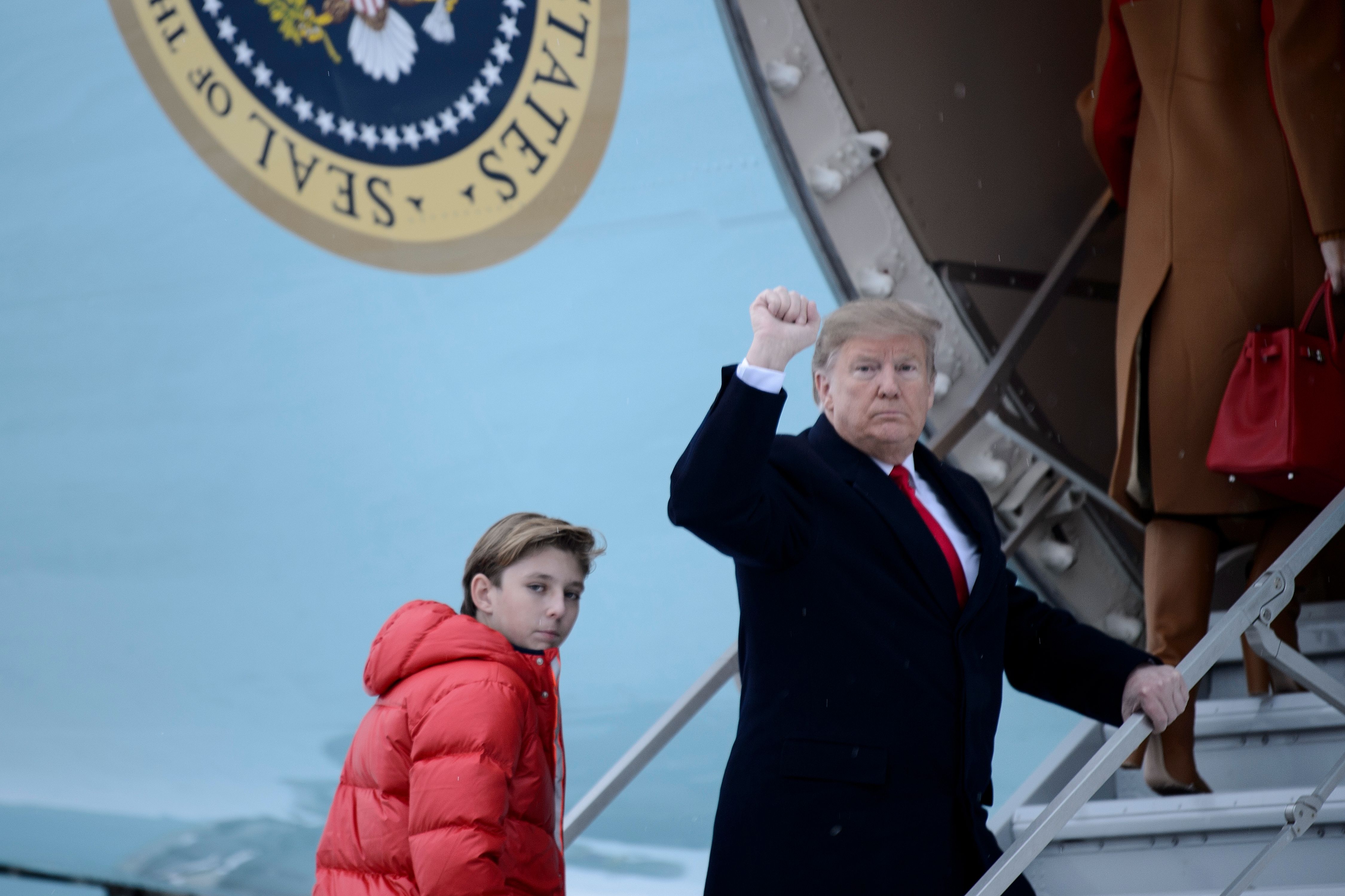 US President Donald Trump and son Barron Trump board Air Force One at Andrews Air Force Base on Feb. 1, 2019, in Maryland, en route to Palm Beach, Fla. (Credit: Brendan Smialowski/AFP/Getty Images)