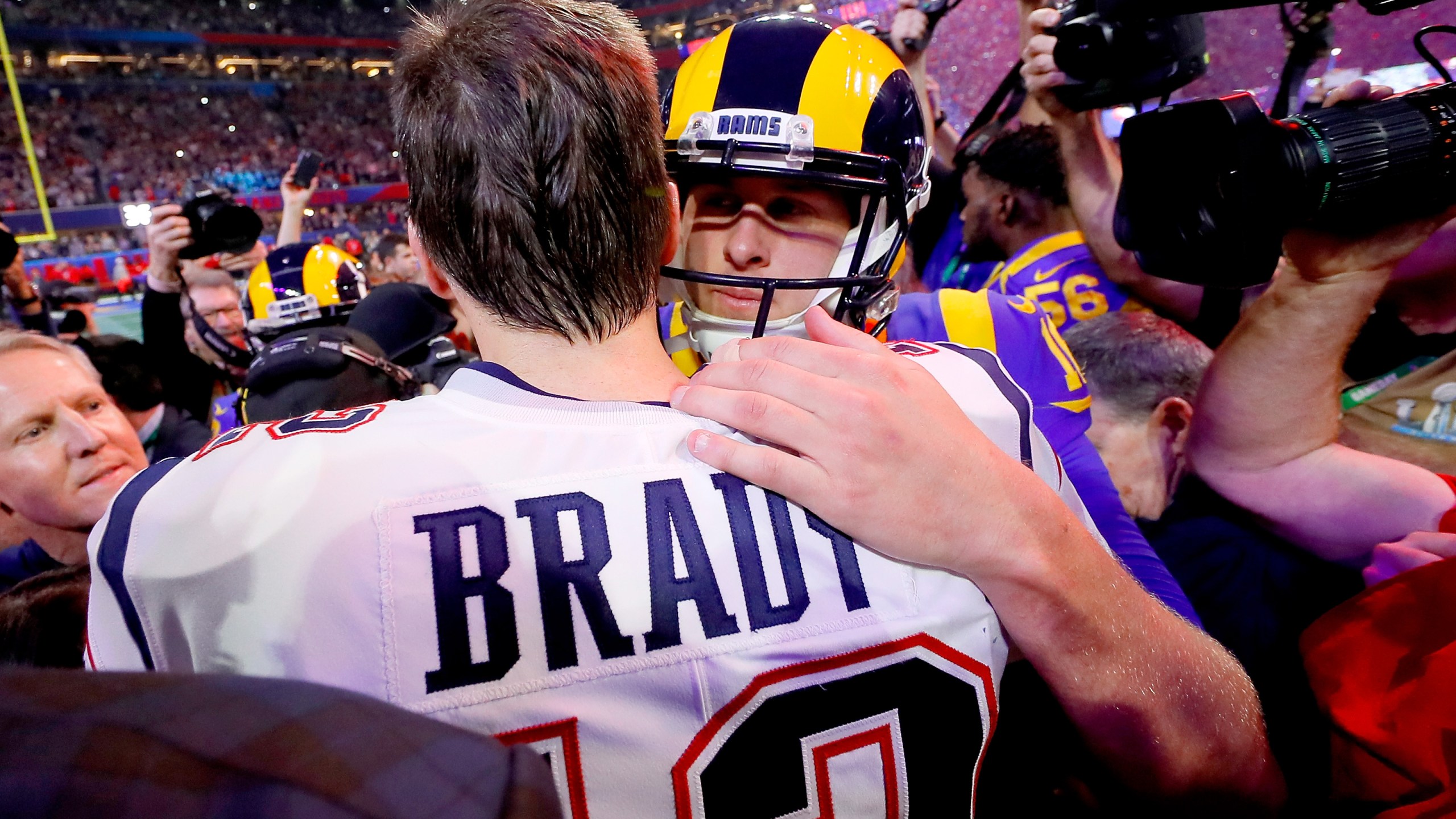 Tom Brady of the New England Patriots hugs Jared Goff of the Los Angeles Rams after the Patriots defeat the Rams 13-3 during Super Bowl LIII at Mercedes-Benz Stadium on Feb. 3, 2019 in Atlanta, Georgia. (Credit: Kevin C. Cox/Getty Images)