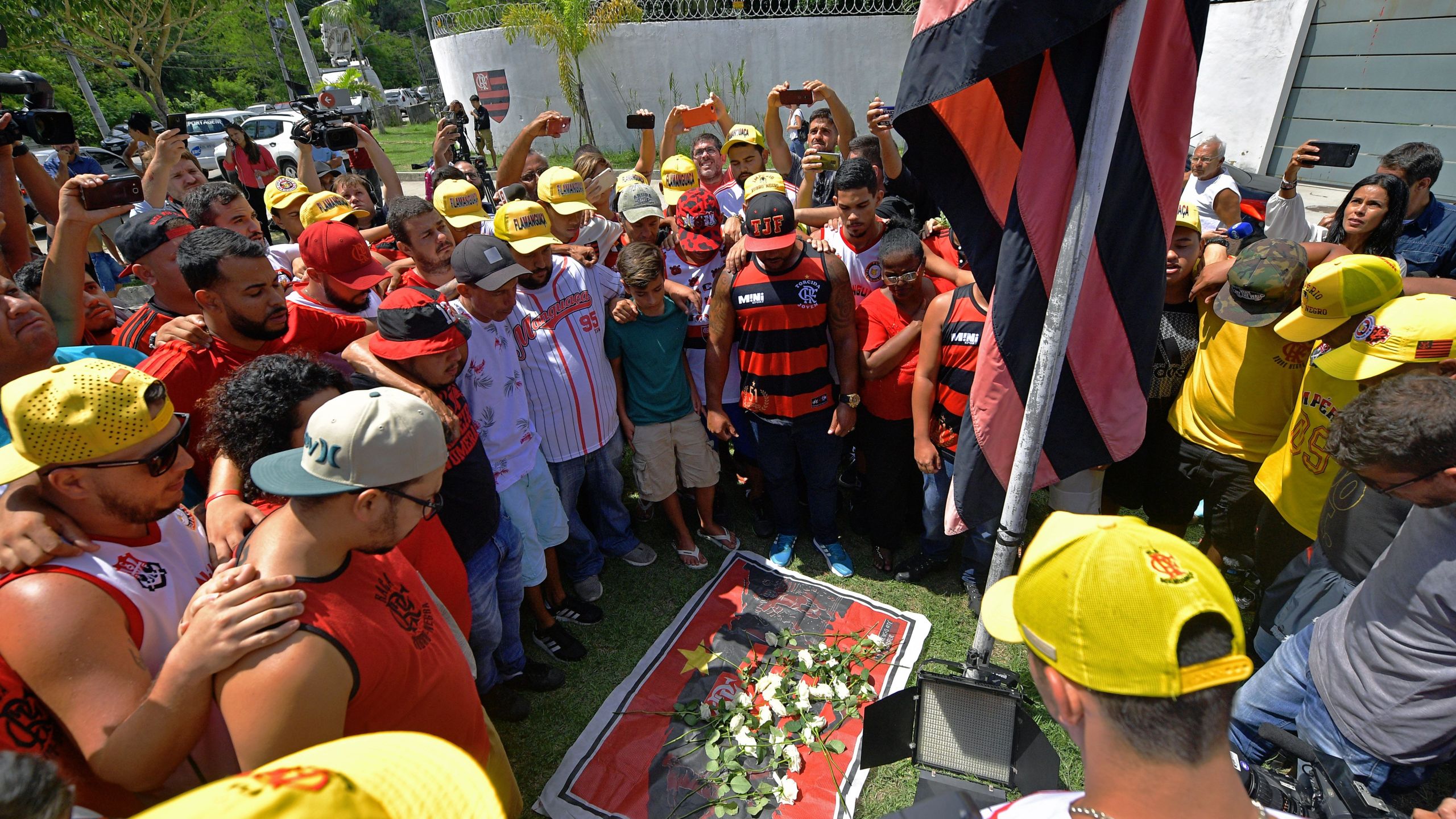 Brazilian football club Flamengo fans gather to lay flowers at the entrance of the club's training center after a deadly fire in Rio de Janeiro, Brazil, on Feb. 8, 2019. (Credit: Carl De Souza / AFP / Getty Images)