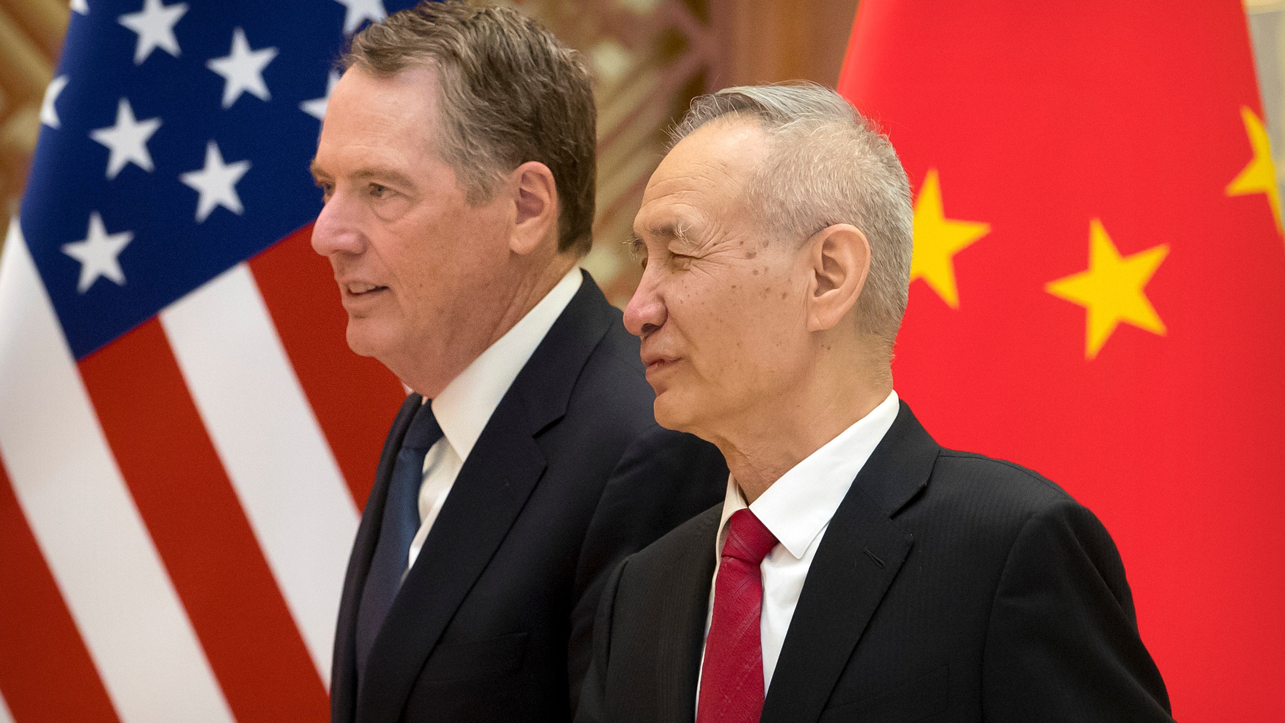 US Trade Representative Robert Lighthizer (L) listens as Chinese Vice Premier Liu He talks while they line up for a group photo at the Diaoyutai State Guesthouse in Beijing on February 15, 2019. (Credit: MARK SCHIEFELBEIN/AFP/Getty Images)