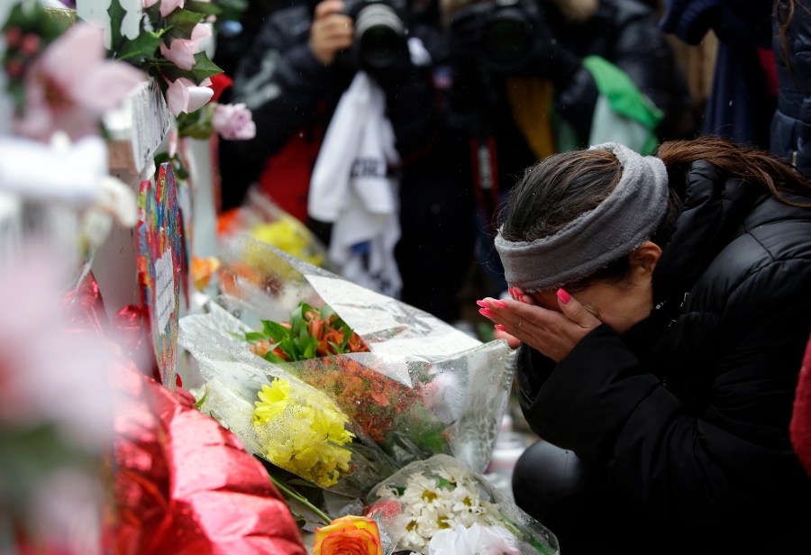 Diana Juarez wipes away tears as she mourns the lost of her father Vicente Juarez during a prayer vigil outside Henry Pratt Company on Feb. 17, 2019, in Aurora, Illinois. (Credit: Joshua Lott/Getty Images)