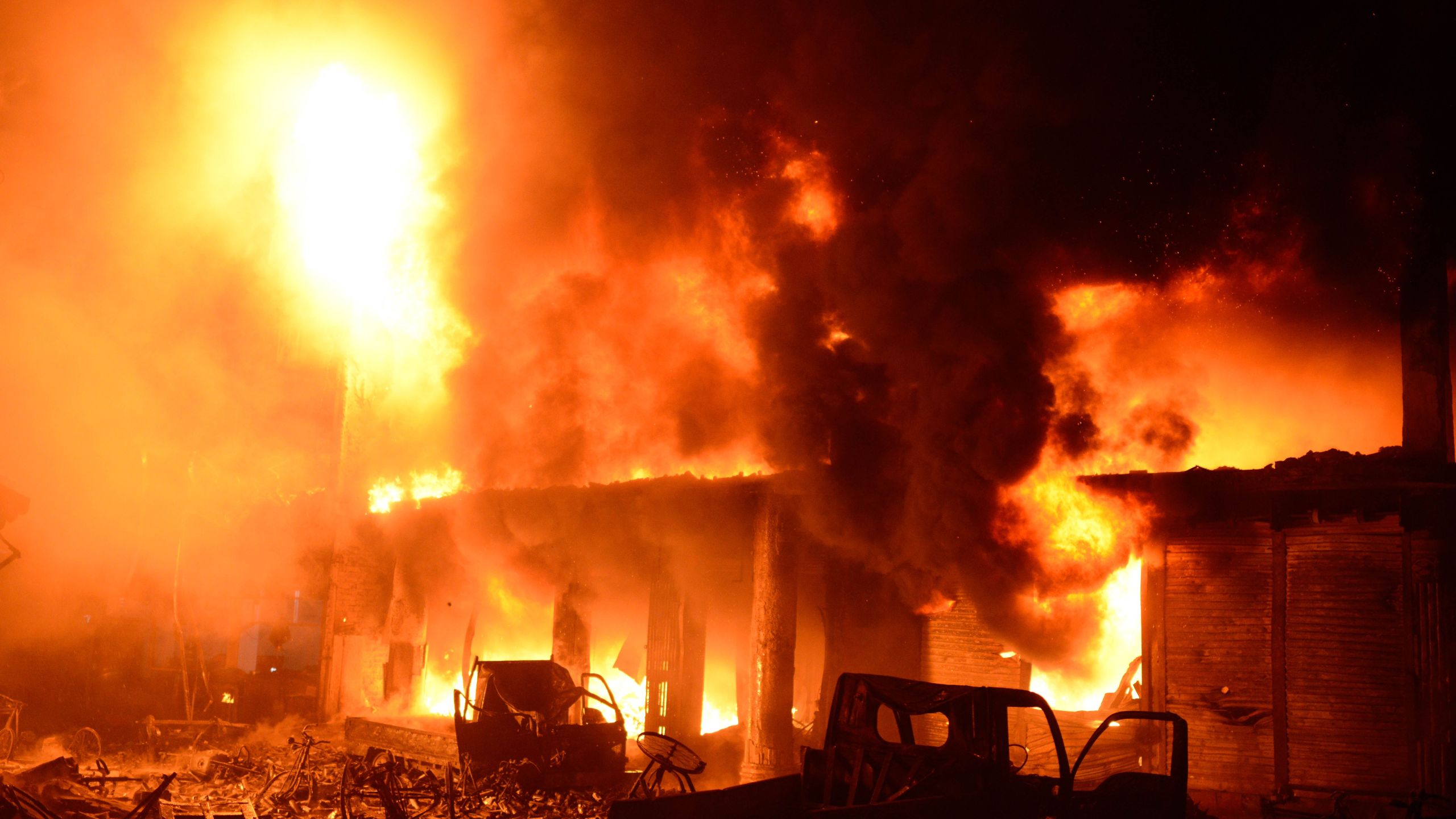 Flames and smoke rise from building after a fire broke out in an old part of the Bangladeshi capital Dhaka on February 21, 2019.(Credit: STR/AFP/Getty Images)