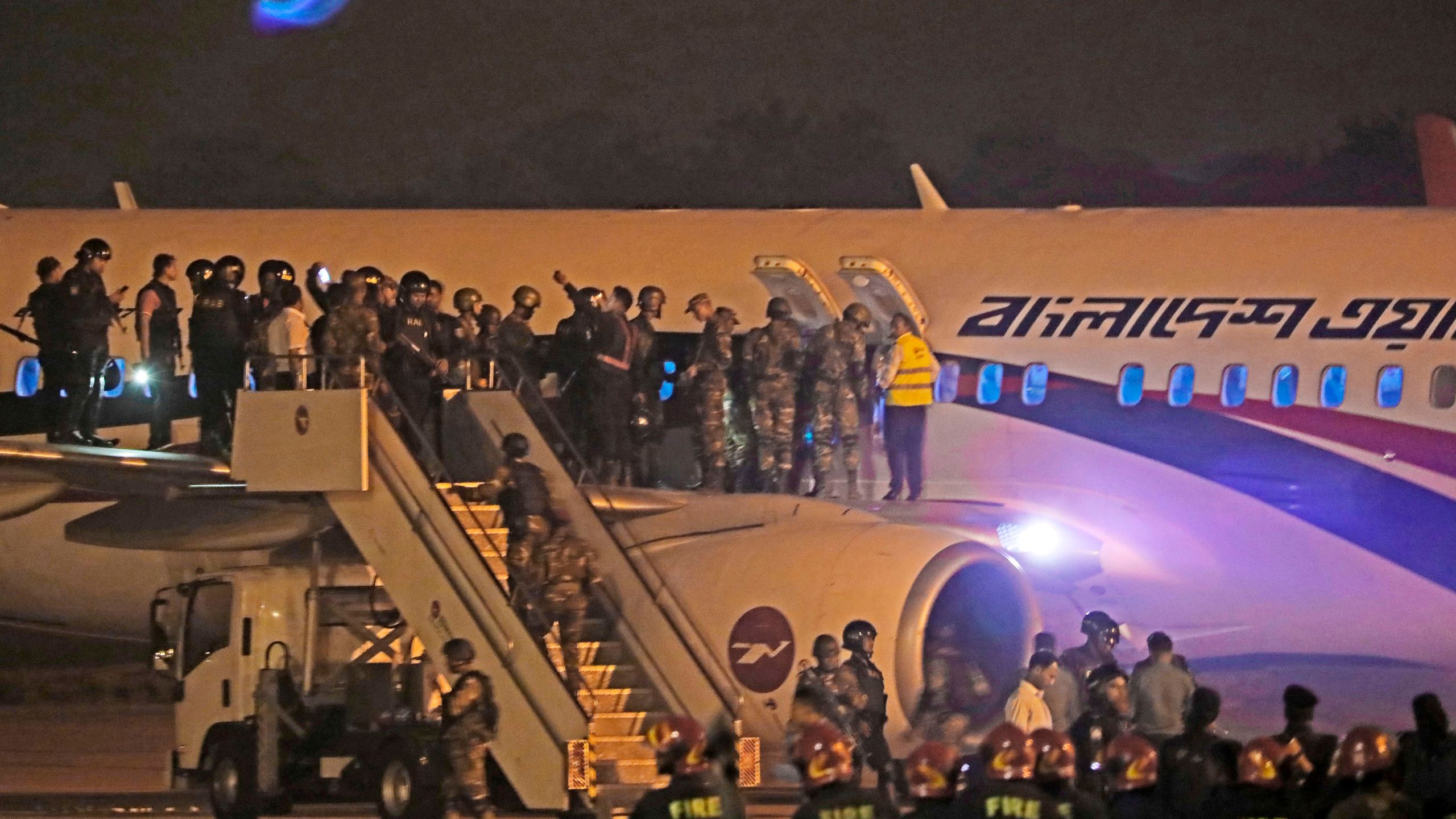 Bangladeshi security personnel stand guard near a Dubai-bound Bangladesh Biman plane on the tarmac of the Shah Amanat International Airport in Chittagong on Feb. 24, 2019, following an emergency landing after a man allegedly attempted to hijack the aircraft. (Credit: STR/AFP/Getty Images)