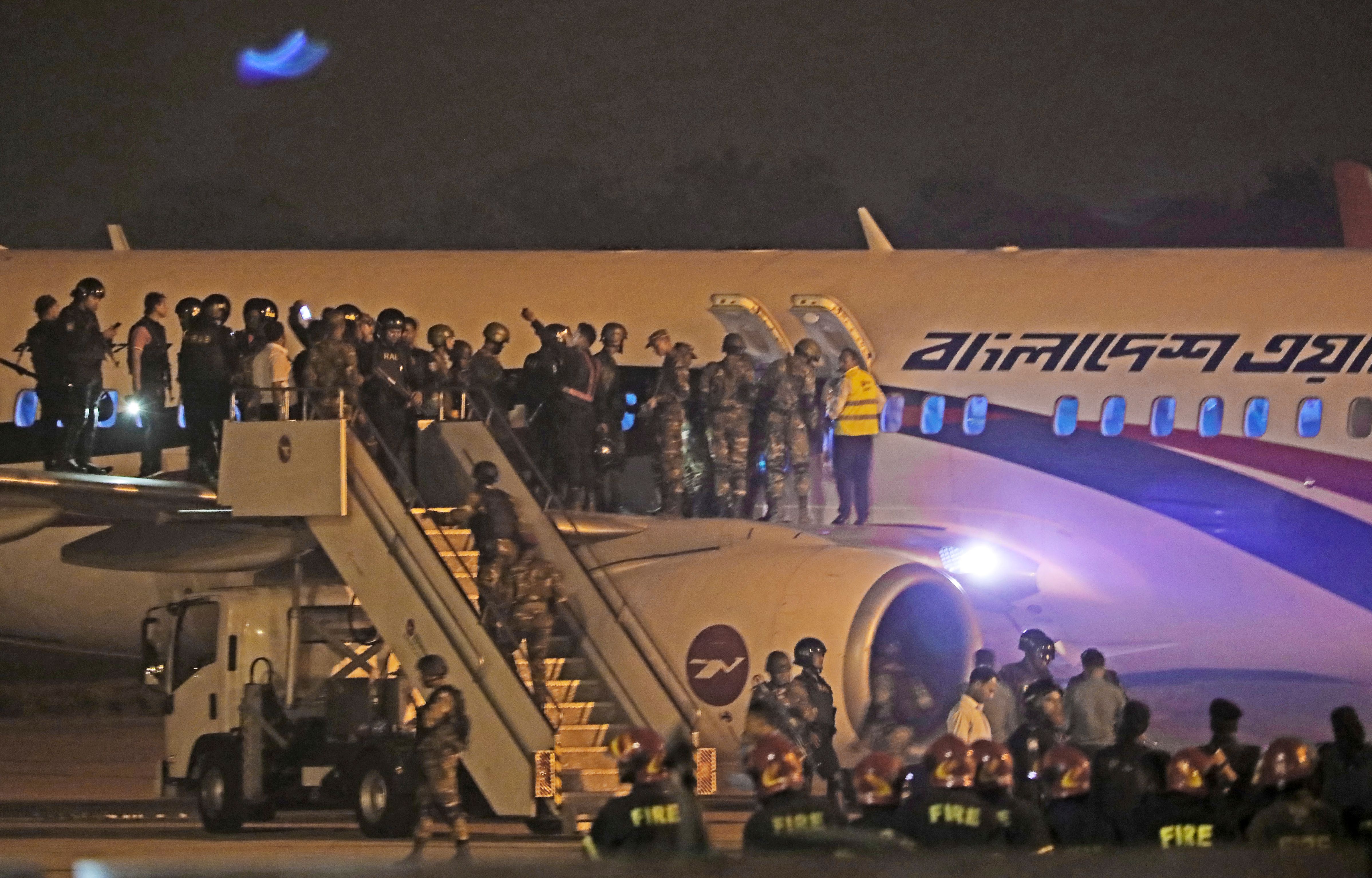 Bangladeshi security personnel stand guard near a Dubai-bound Bangladesh Biman plane on the tarmac of the Shah Amanat International Airport in Chittagong on Feb. 24, 2019, following an emergency landing after a man allegedly attempted to hijack the aircraft. (Credit: STR/AFP/Getty Images)