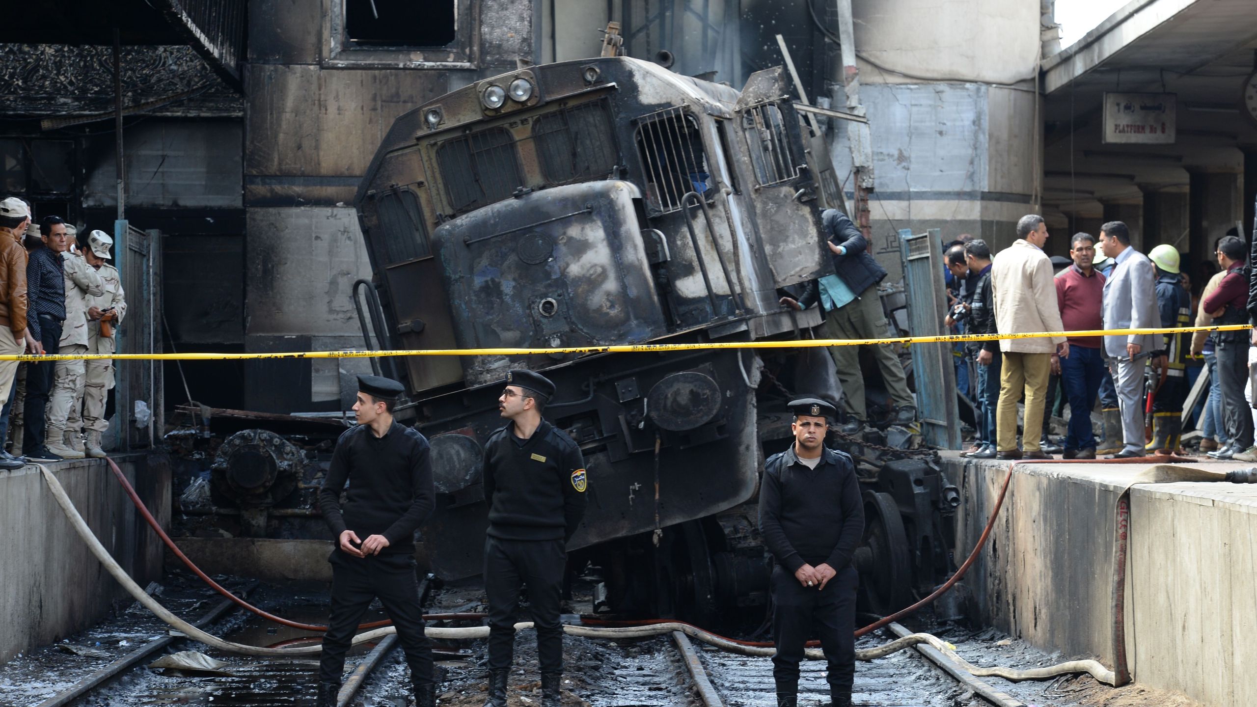 Members of the security forces and onlookers gather at the scene of a fiery train crash at the Egyptian capital Cairo's main railway station on Feb. 27, 2019. (Credit: MOHAMED EL-SHAHED/AFP/Getty Images)